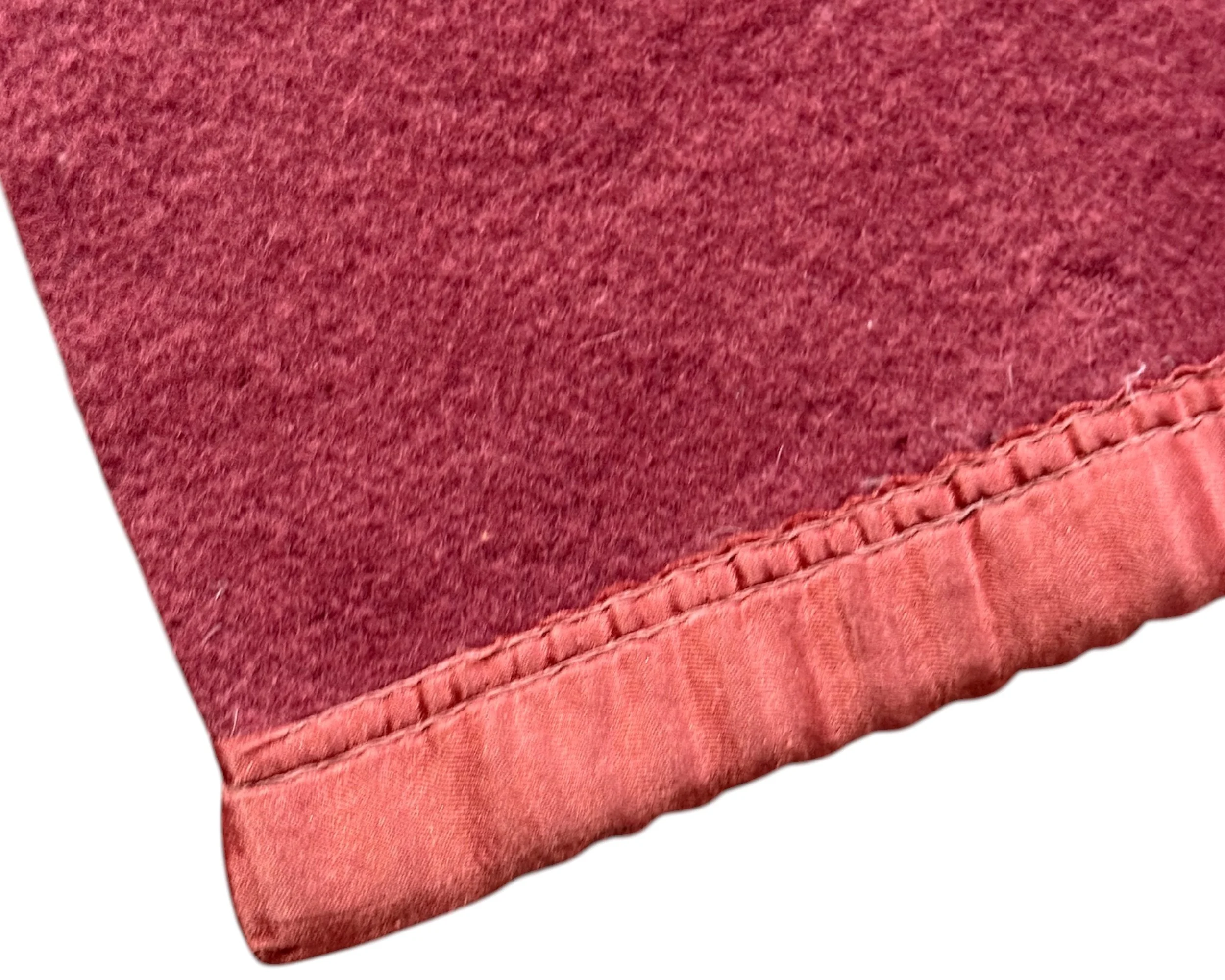 close up detail of satin trim on vintage wool blanket