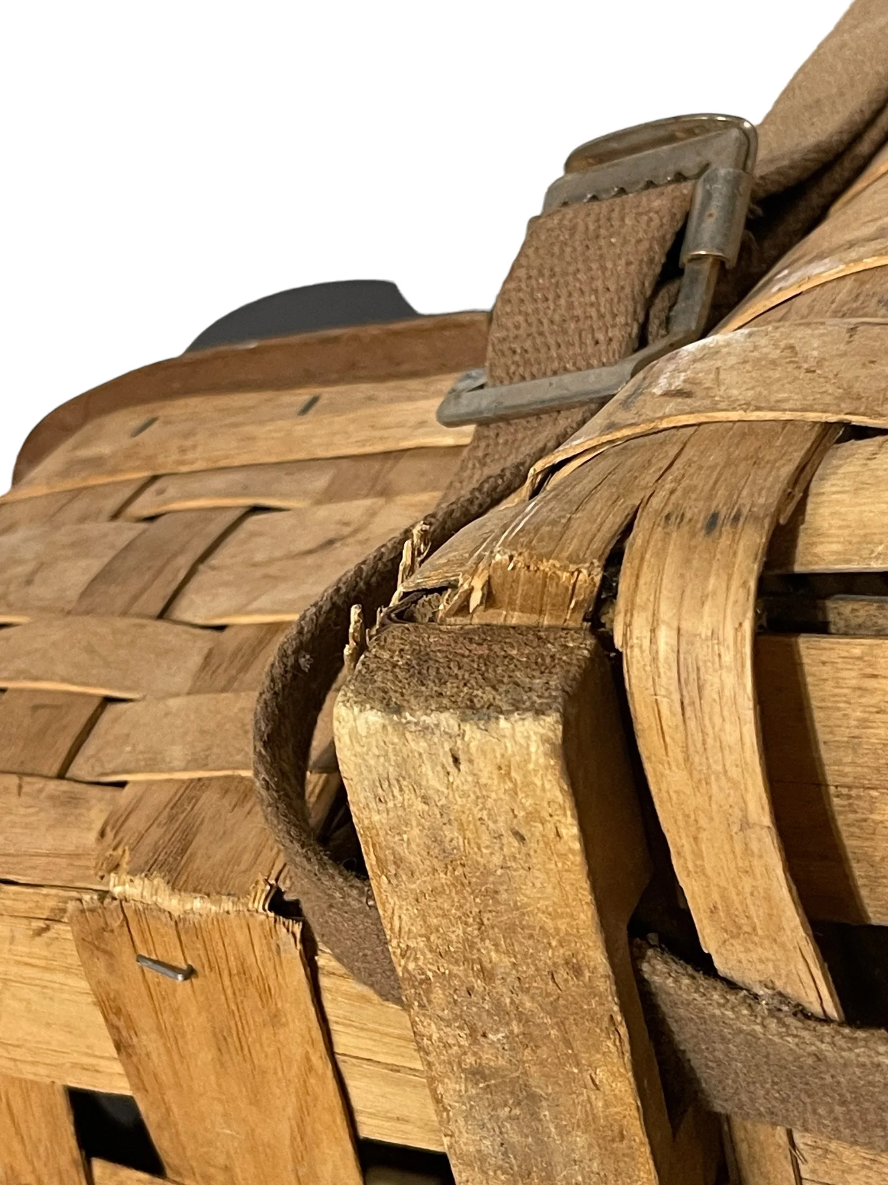 Close up view of a large vintage Adirondack Pack Basket - 2 Compartments, 1 with lid, canvas adjustable shoulder straps.