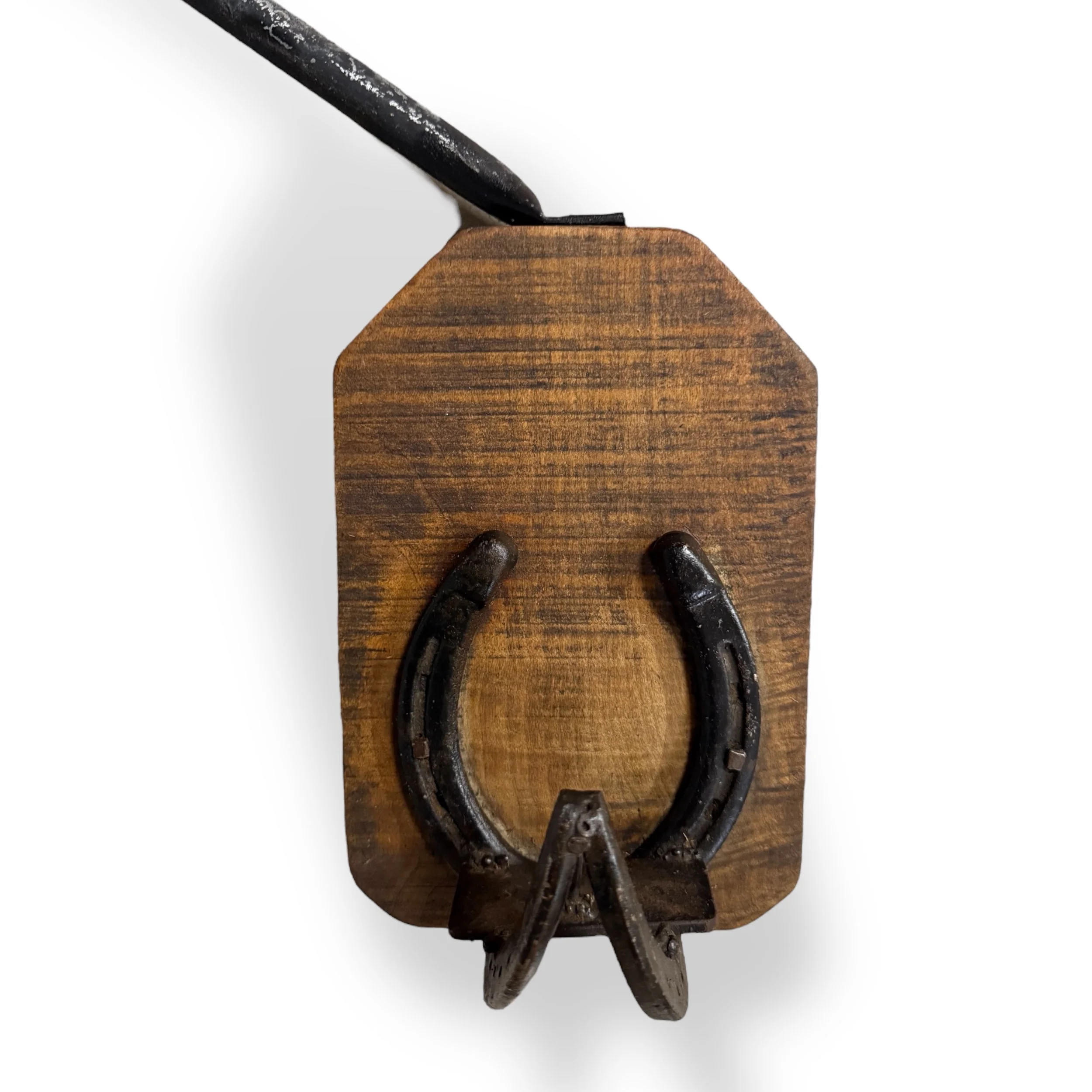 Close up front view of a handmade wood and horseshoe coat rack and candle holder