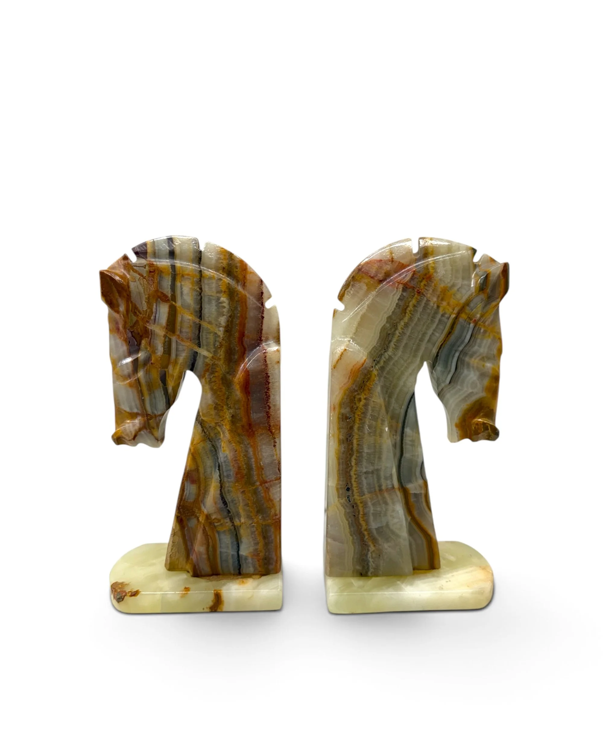 Vintage equestrian bookends featuring matching carved horse heads on natural stone base.