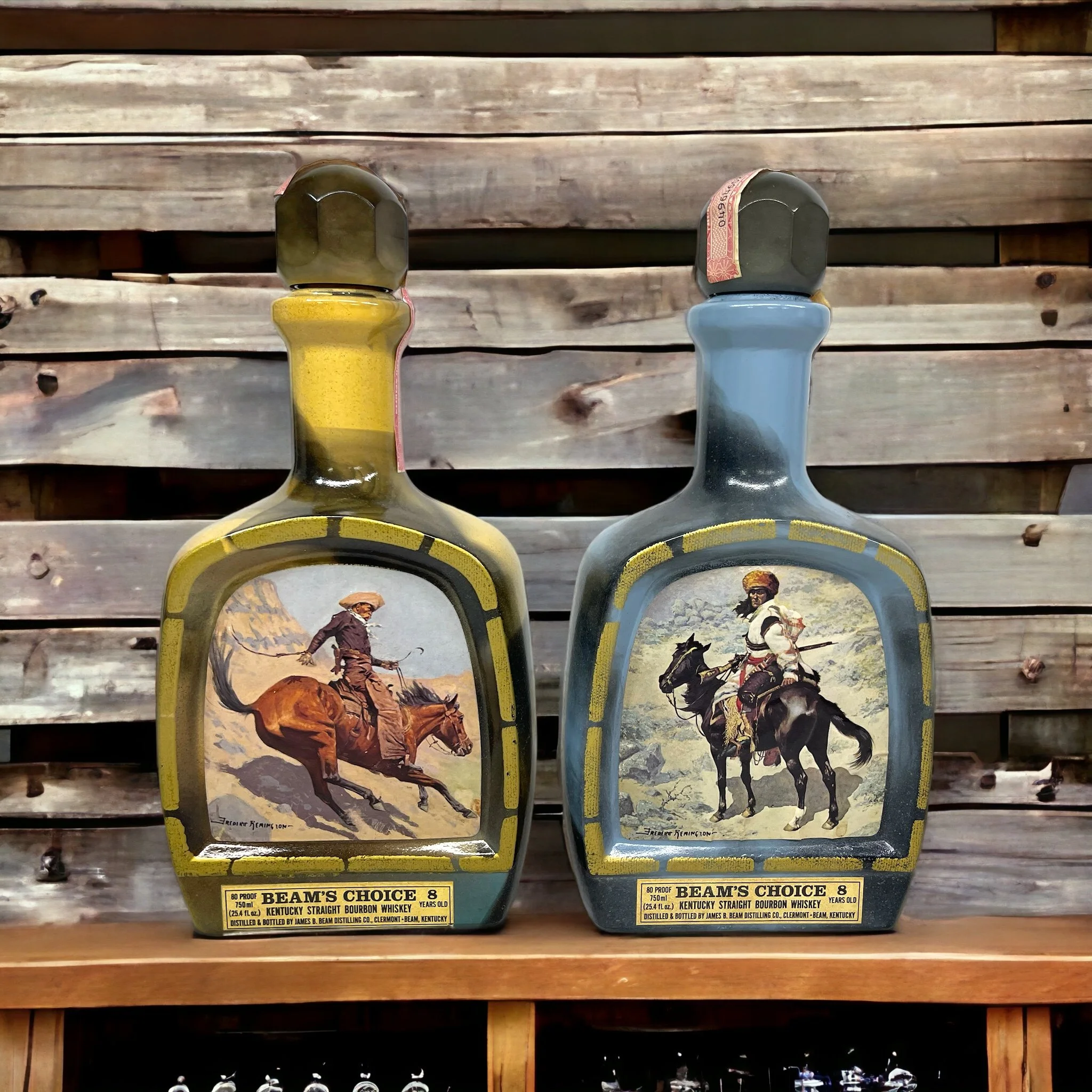 Vintage pair of glass 1970s Jim Beam Choice liquor bottles, featuring the cowboy and the Indian trapper. Perfect home bar decor.