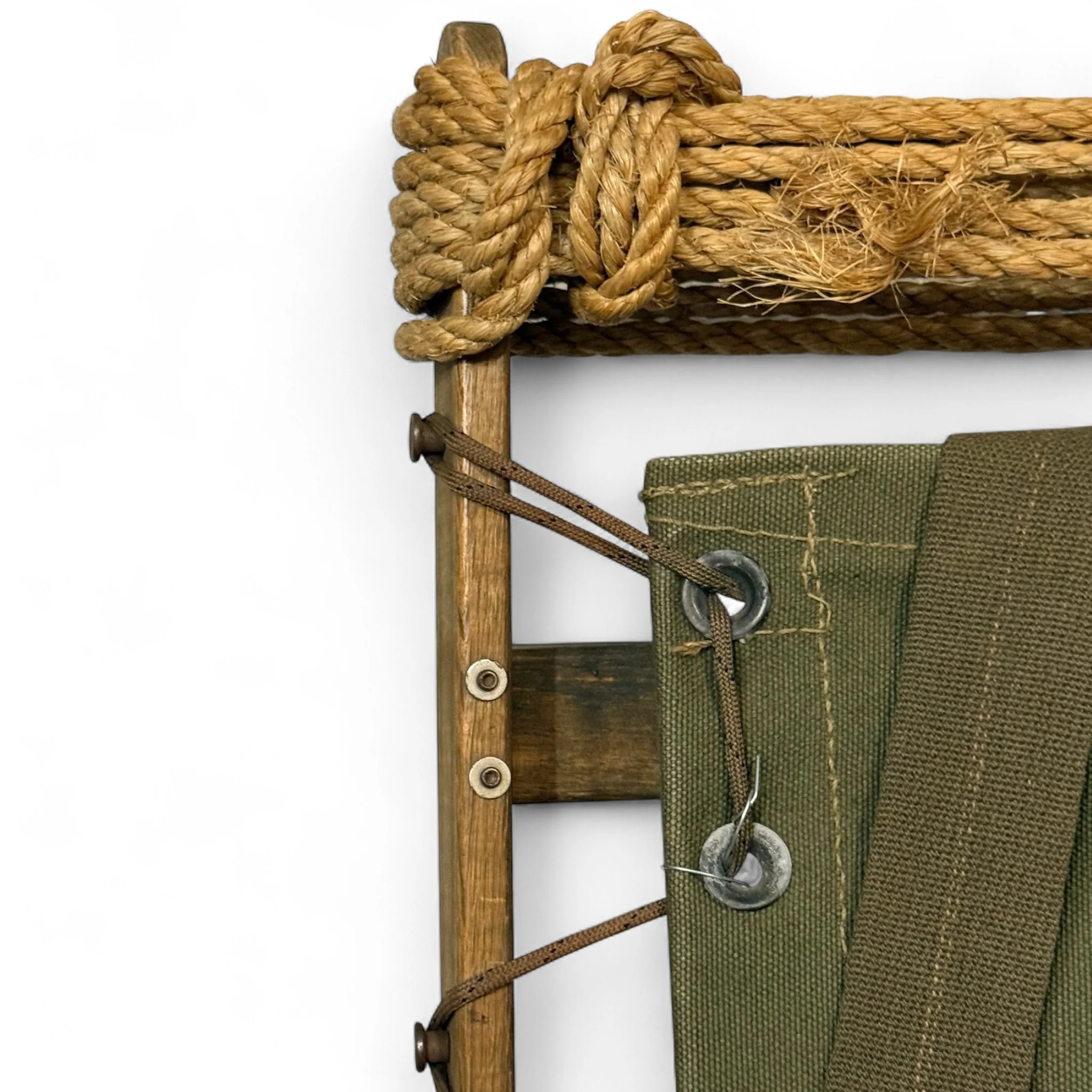 Close up of wood, rope, and canvas details on a vintage wooden packboard.