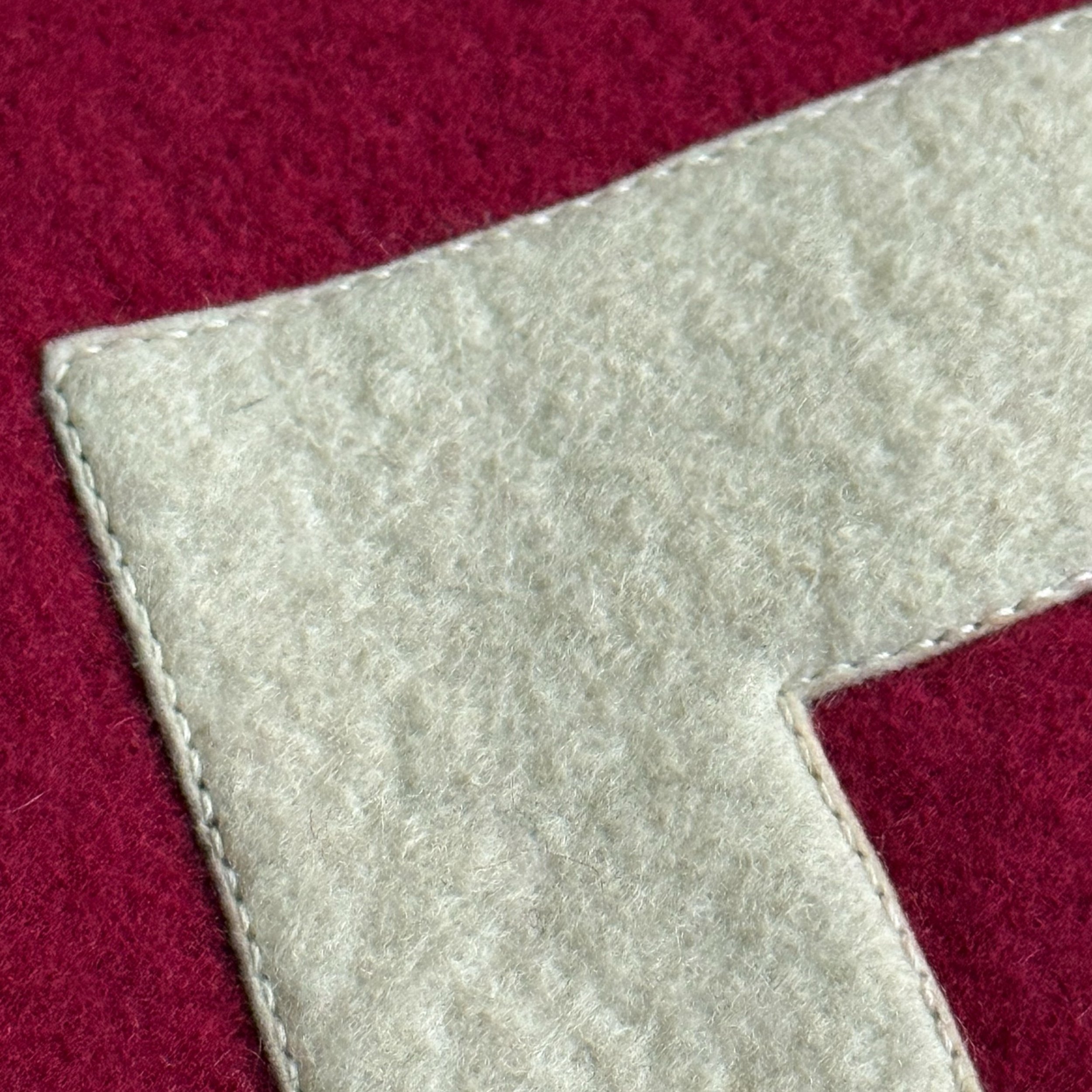 close up view of stitching around lettering on vintage Harvard felt banner - authentic collegiate alumni wall decor