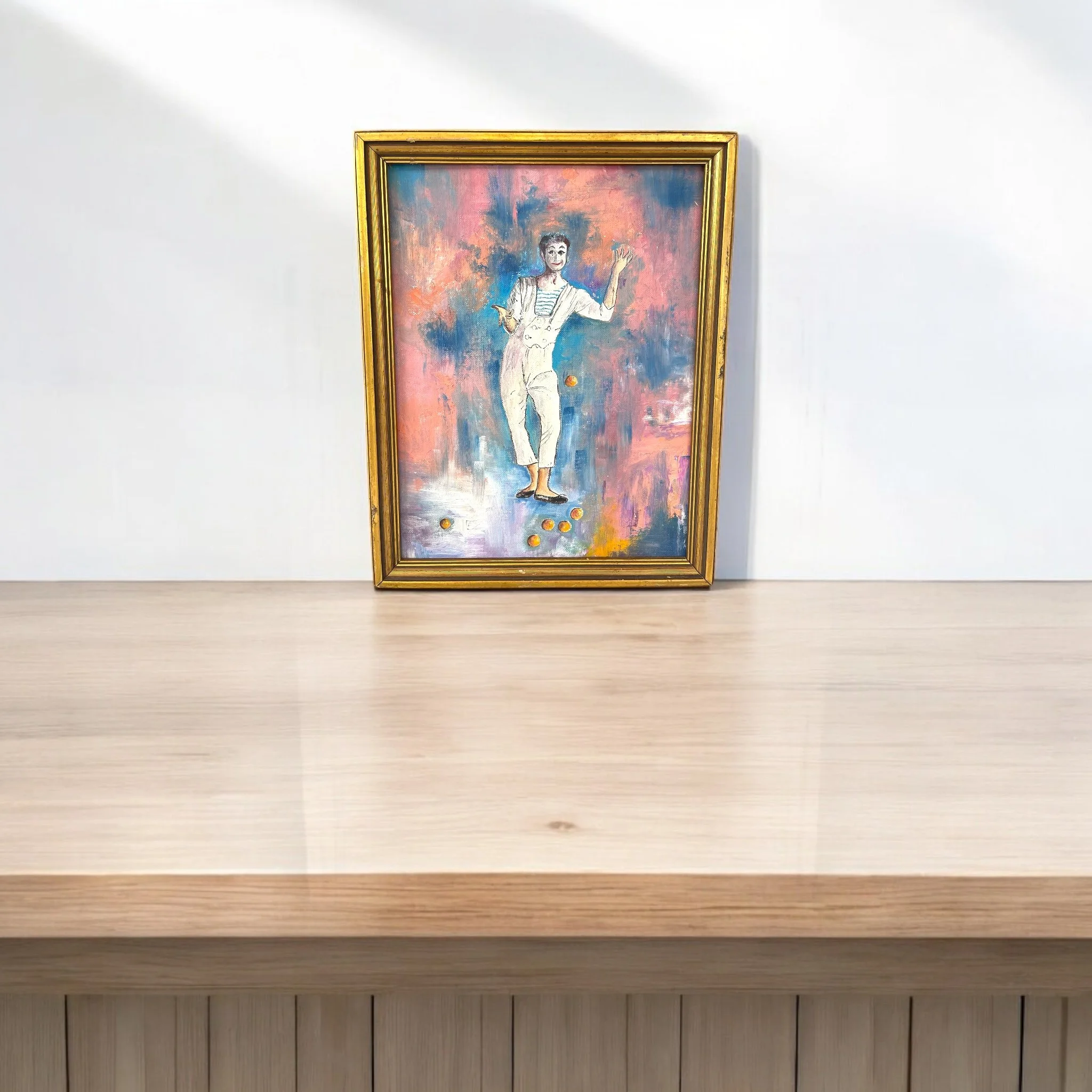 Vintage original colorful painting of a clown, mime juggling balls in a palette of vibrant pink, blue, orange, and white. Wood, gold painted frame.