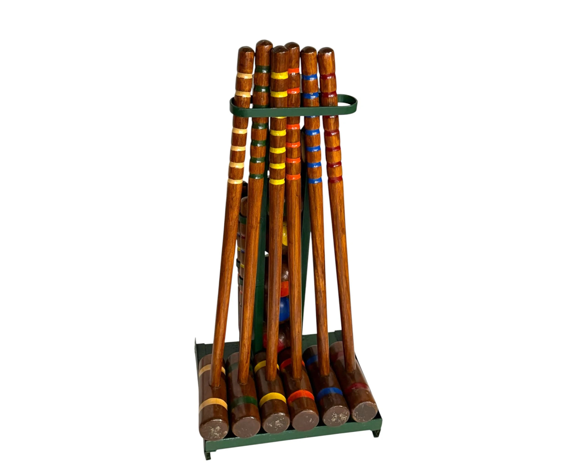 front view of set of vintage croquet mallets with colored rings in stand