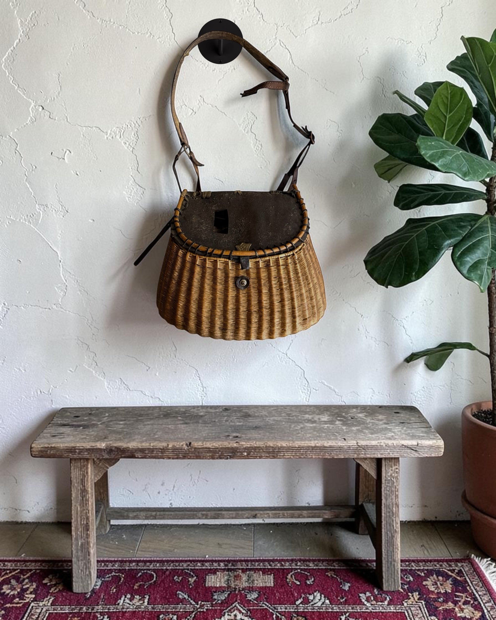 woven 1950s fishing creel hanging on a wall for rustic lodge decor