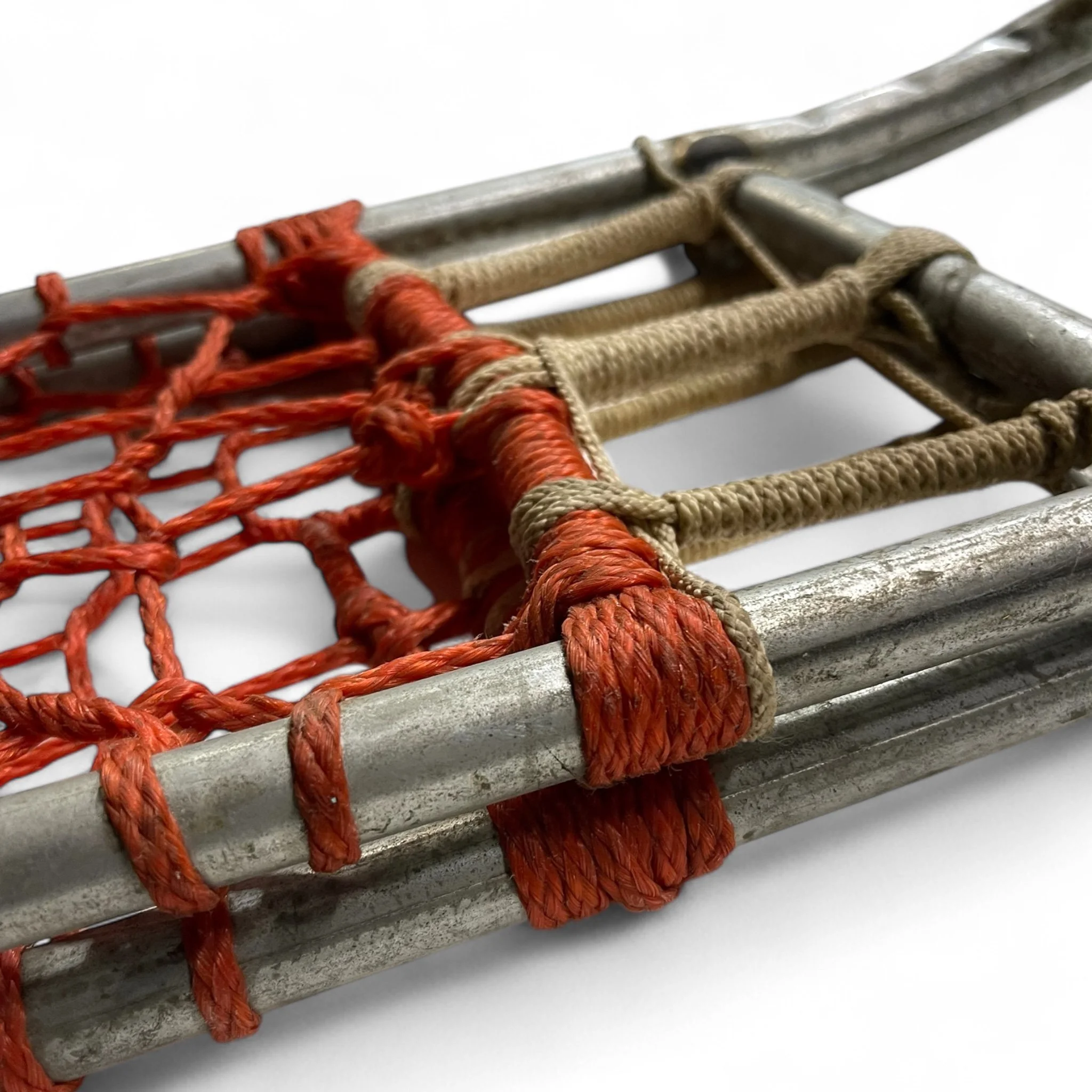 Pair of vintage metal snowshoes with orange and beige rope, perfect for rustic cabin decor, ski lodge wall art, or winter inspired home accents.