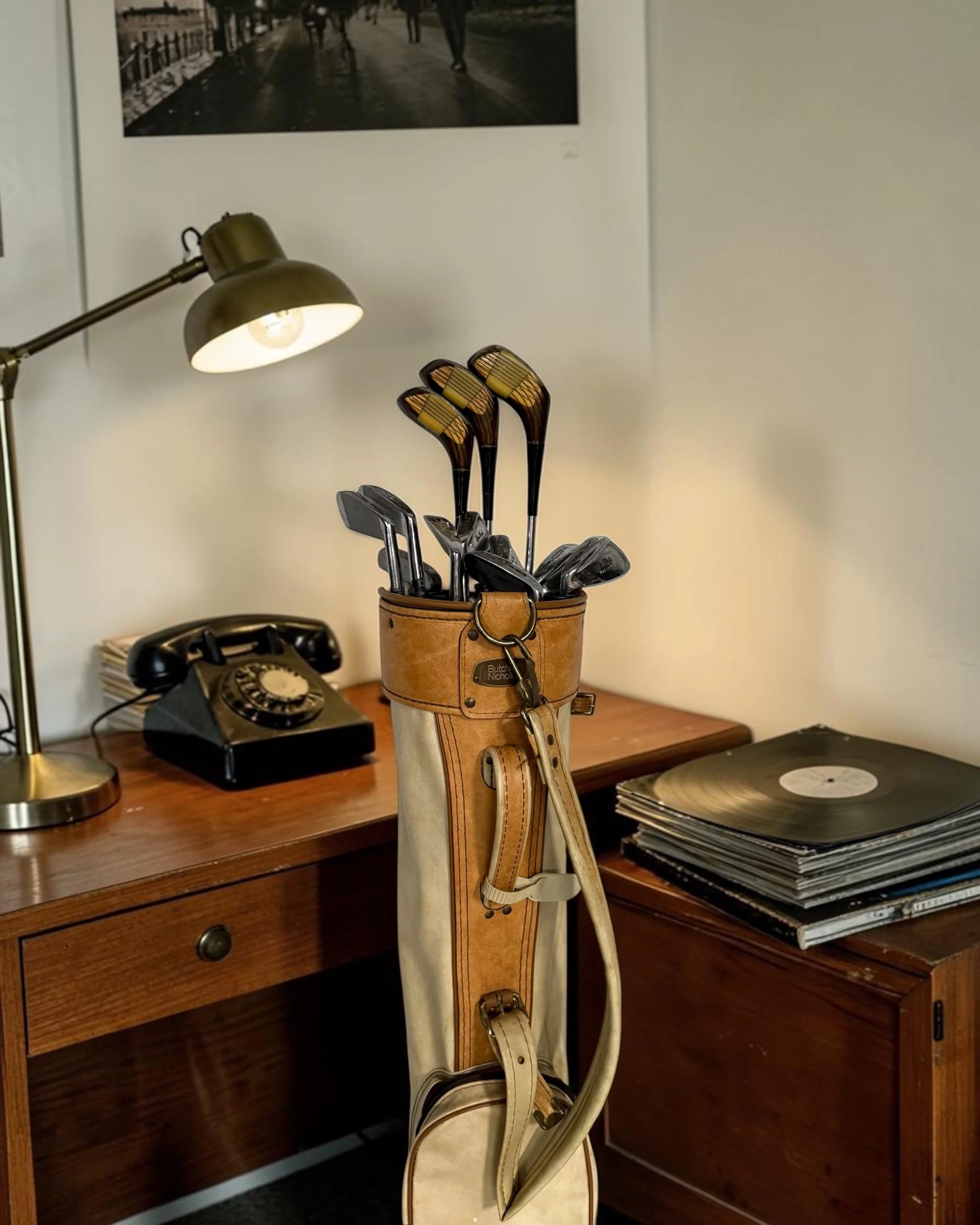 Vintage women’s golf equipment collection from the 1970s styled in an office setting