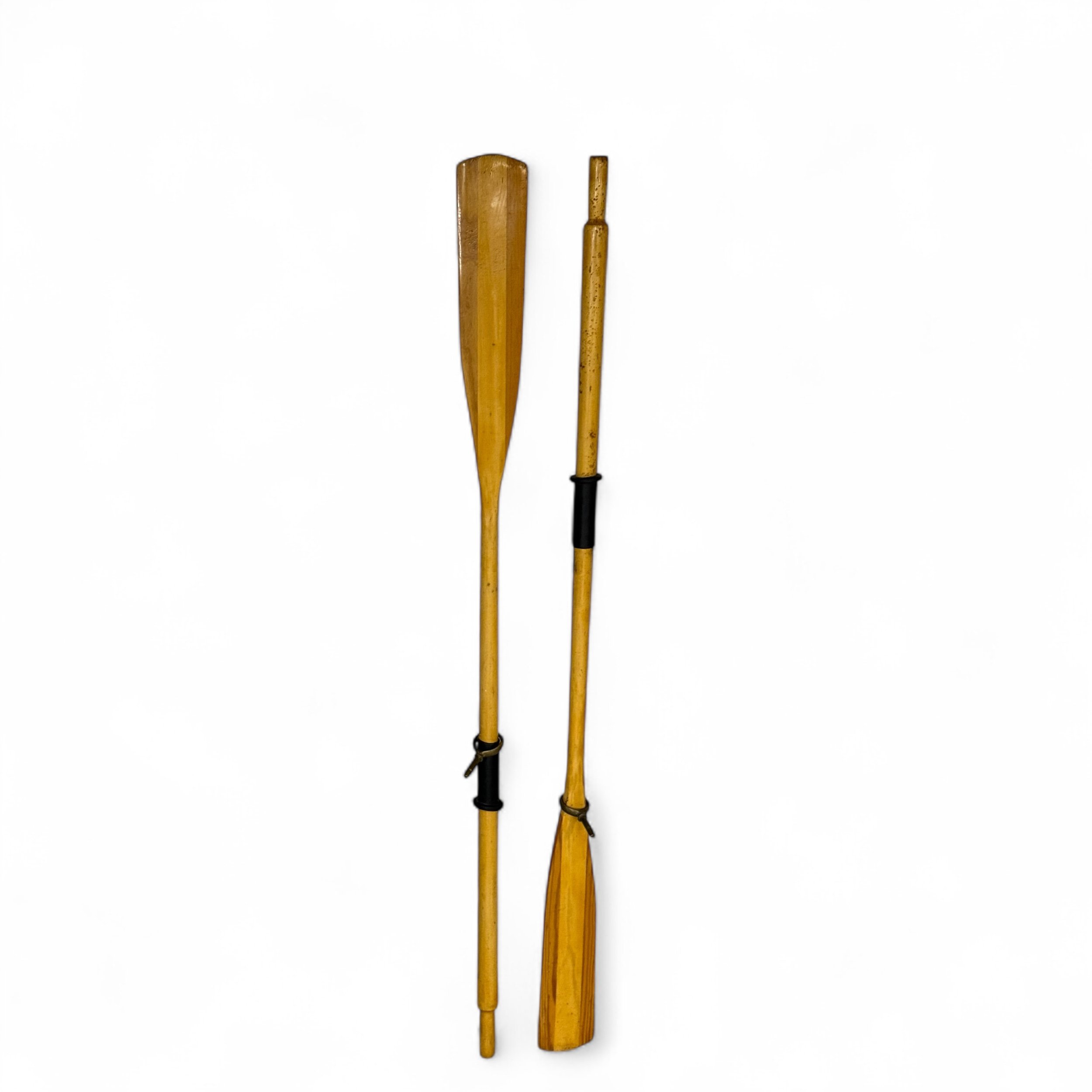 Pair of vintage wooden boat oars with black rubber handle grips and brass oar locks 71 inches long. Rustic nautical decor