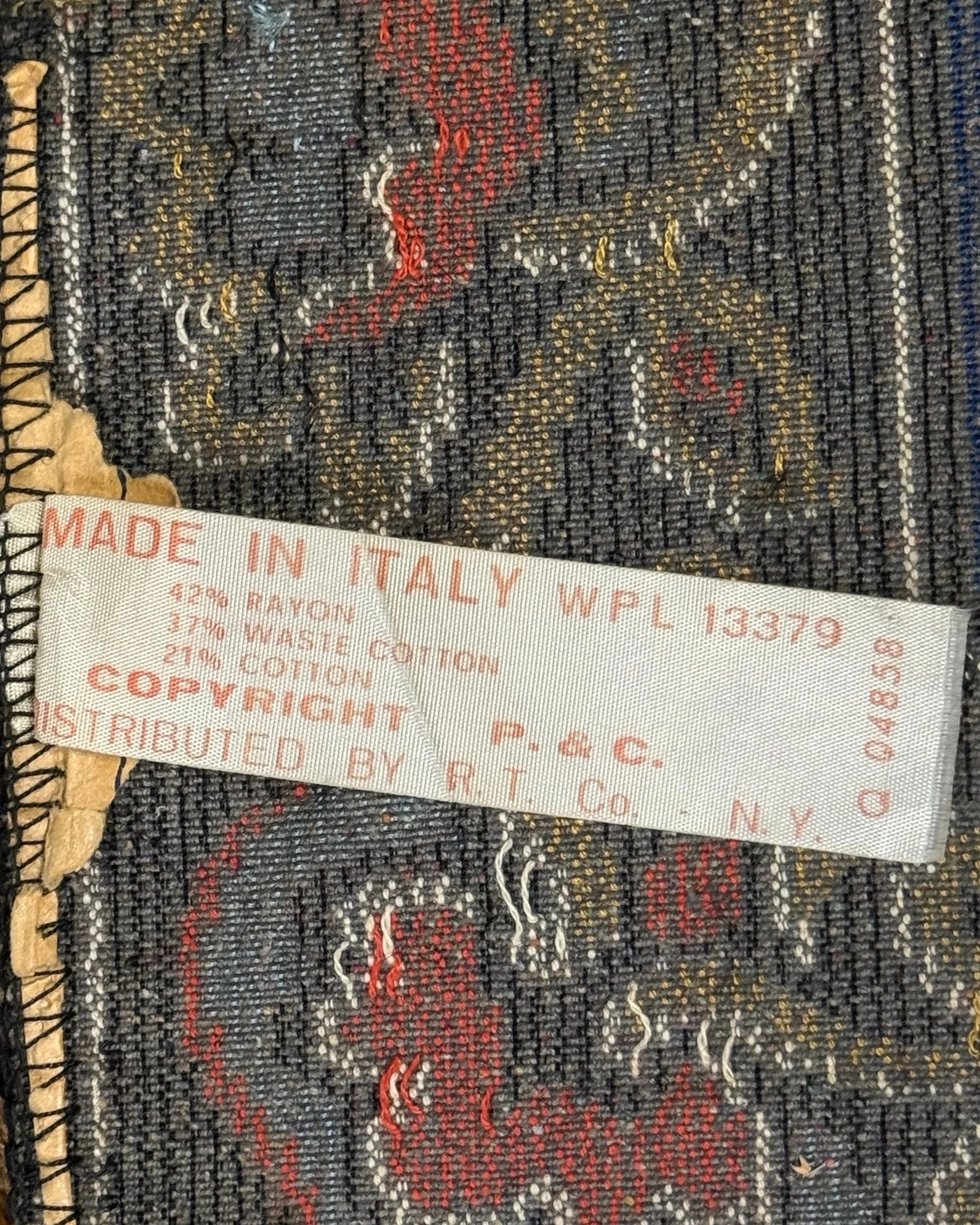 label on vintage tapestry that reads "Made in Italy WPL13379 42% Rayon, 37% Waste Cotton, 21% Cotton, Copyright P. & C. Distributed by R. T. Co. NY