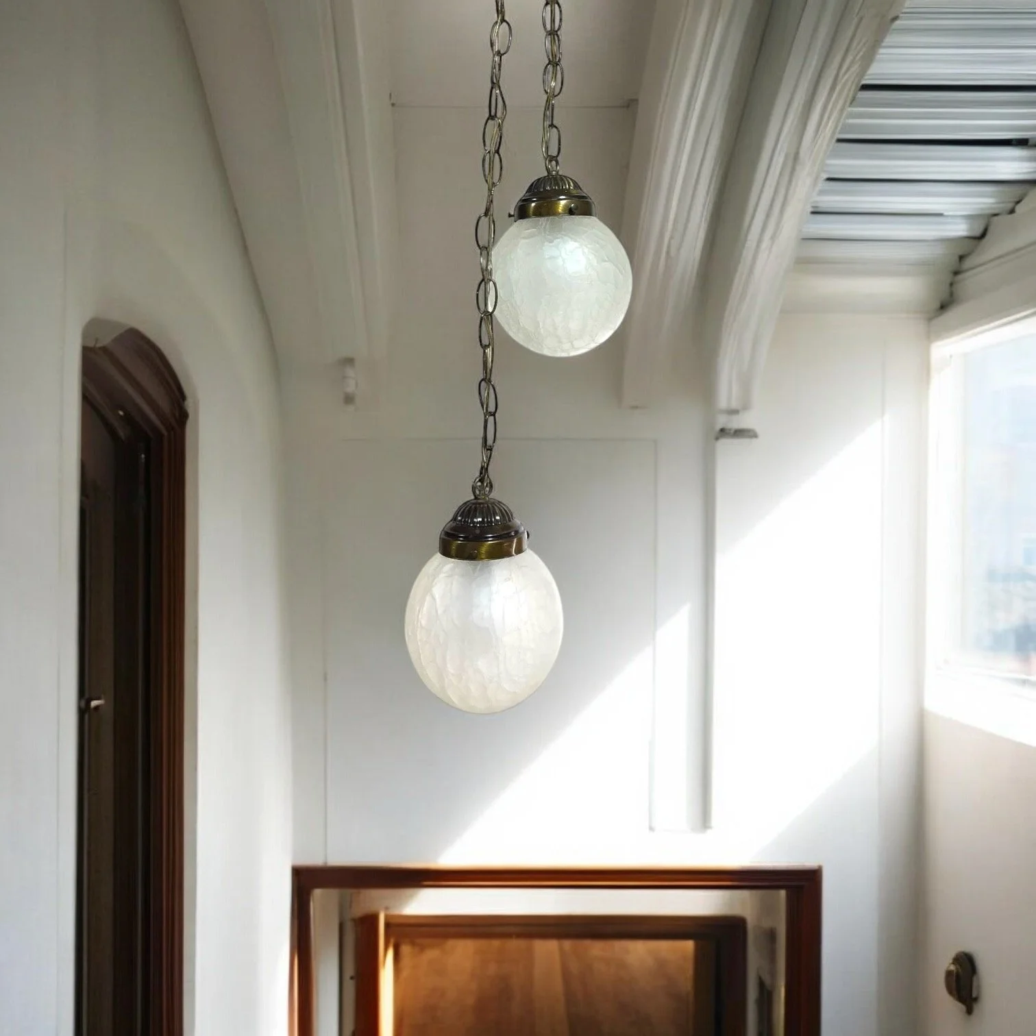 Pair of vintage hardwired crackle glass globe pendant hanging lights by Spring Lighting Corp.