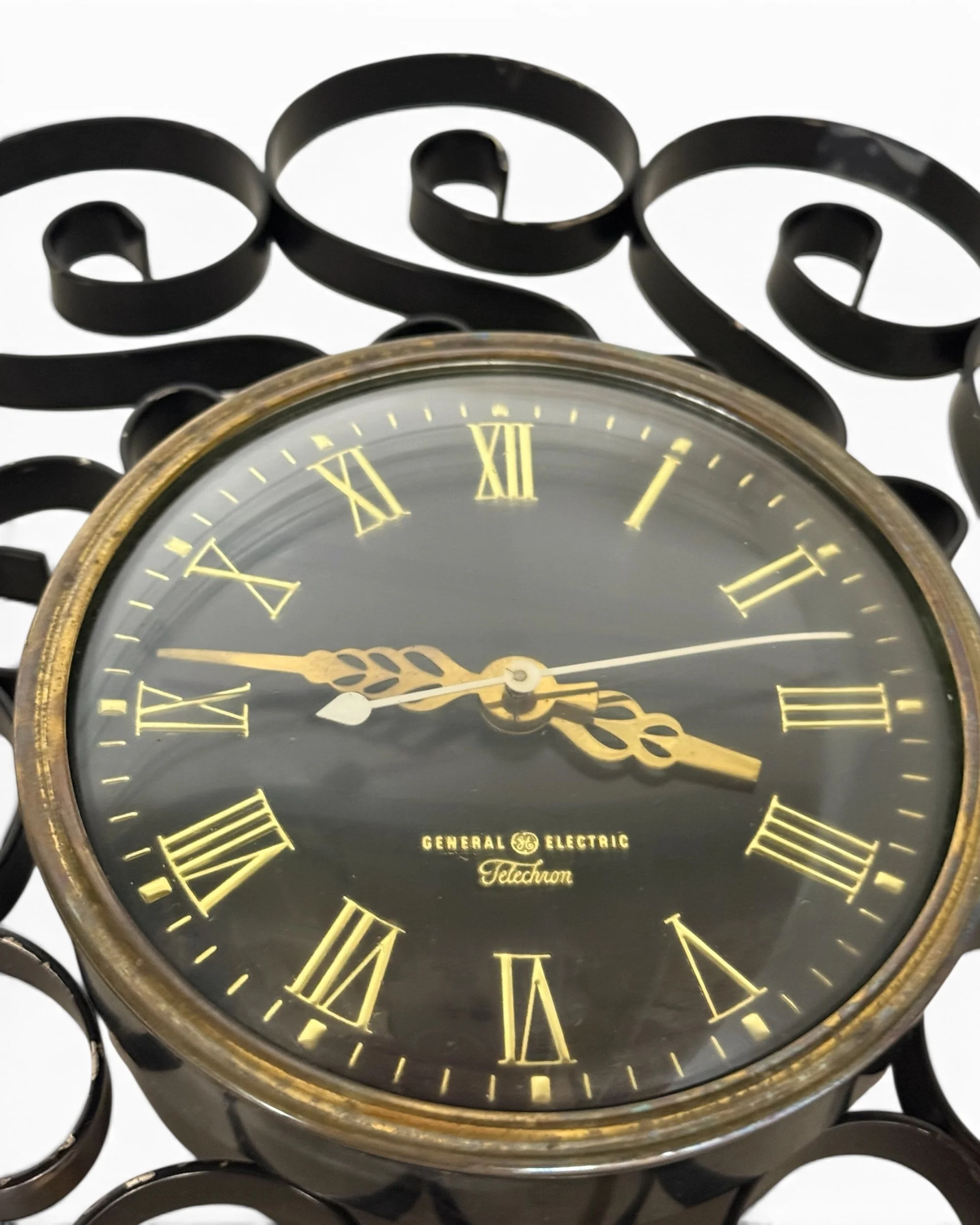 Vintage GE Telechron clock face showing classic numbers and retro American electric clock styling.