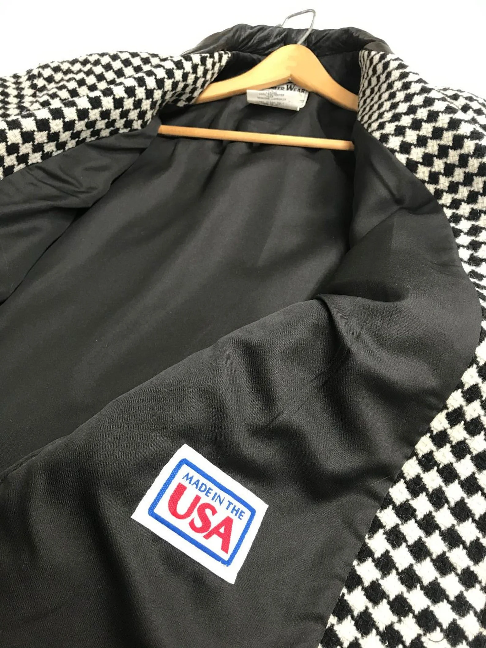 Vintage Pioneer Wear womens size medium black and white houndstooth coat, fully lined, trimmed in black leather, button front closure, two side pockets.