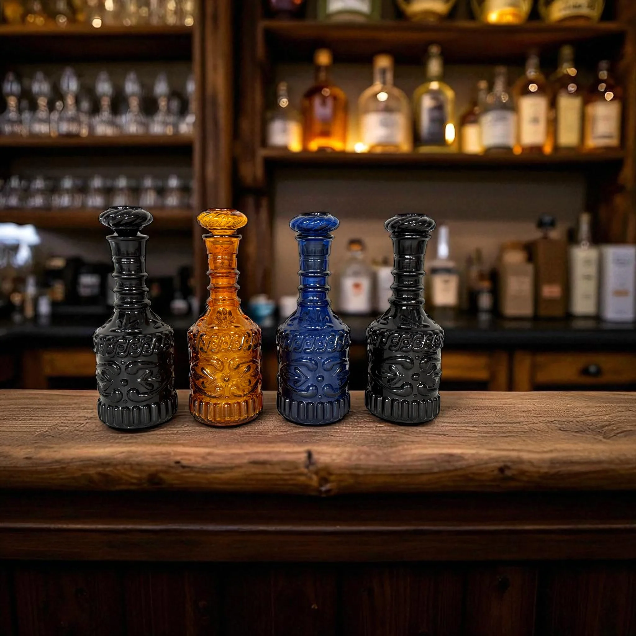 Set of 4 vintage 1970s Jim Beam glass liquor bottles in blue, amber, and black shown styled in a rustic western bar.