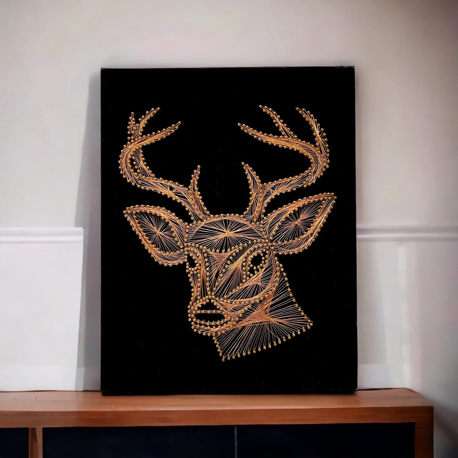 Vintage copper string art of a male deer, buck, on a black velvet board.