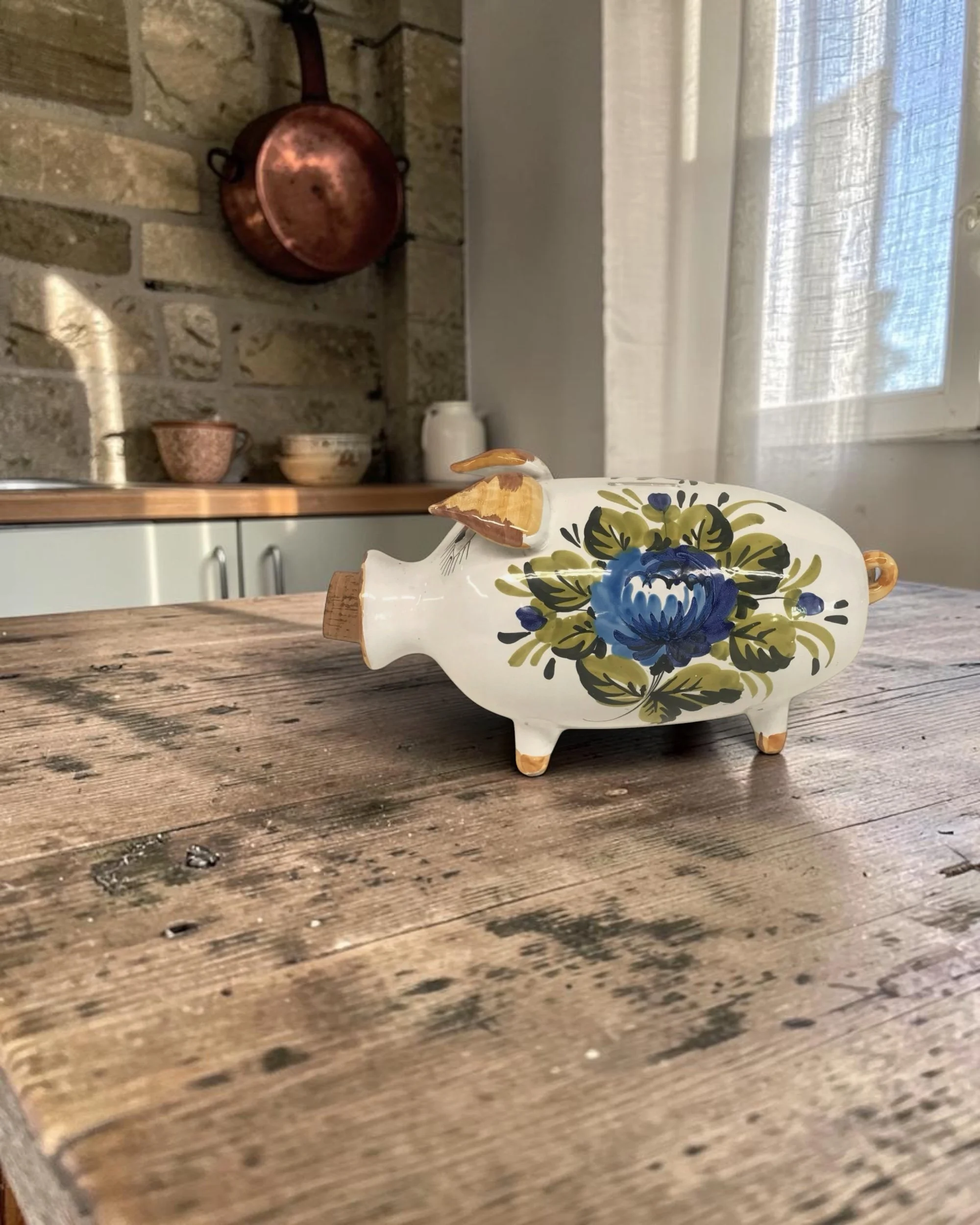large vintage ceramic piggy bank with hand painted floral details styled in a French country kitchen, made in Italy.