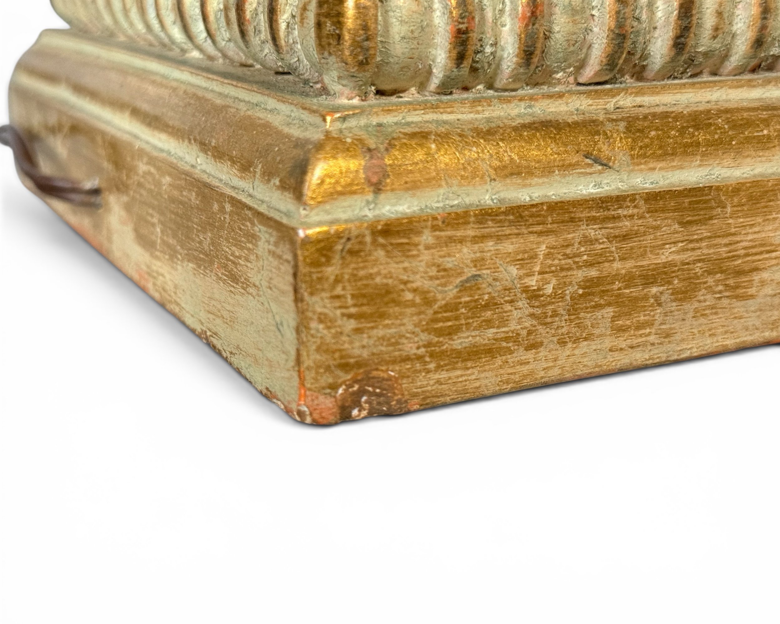 Square pedestal base with decorative trim on vintage lamp.
