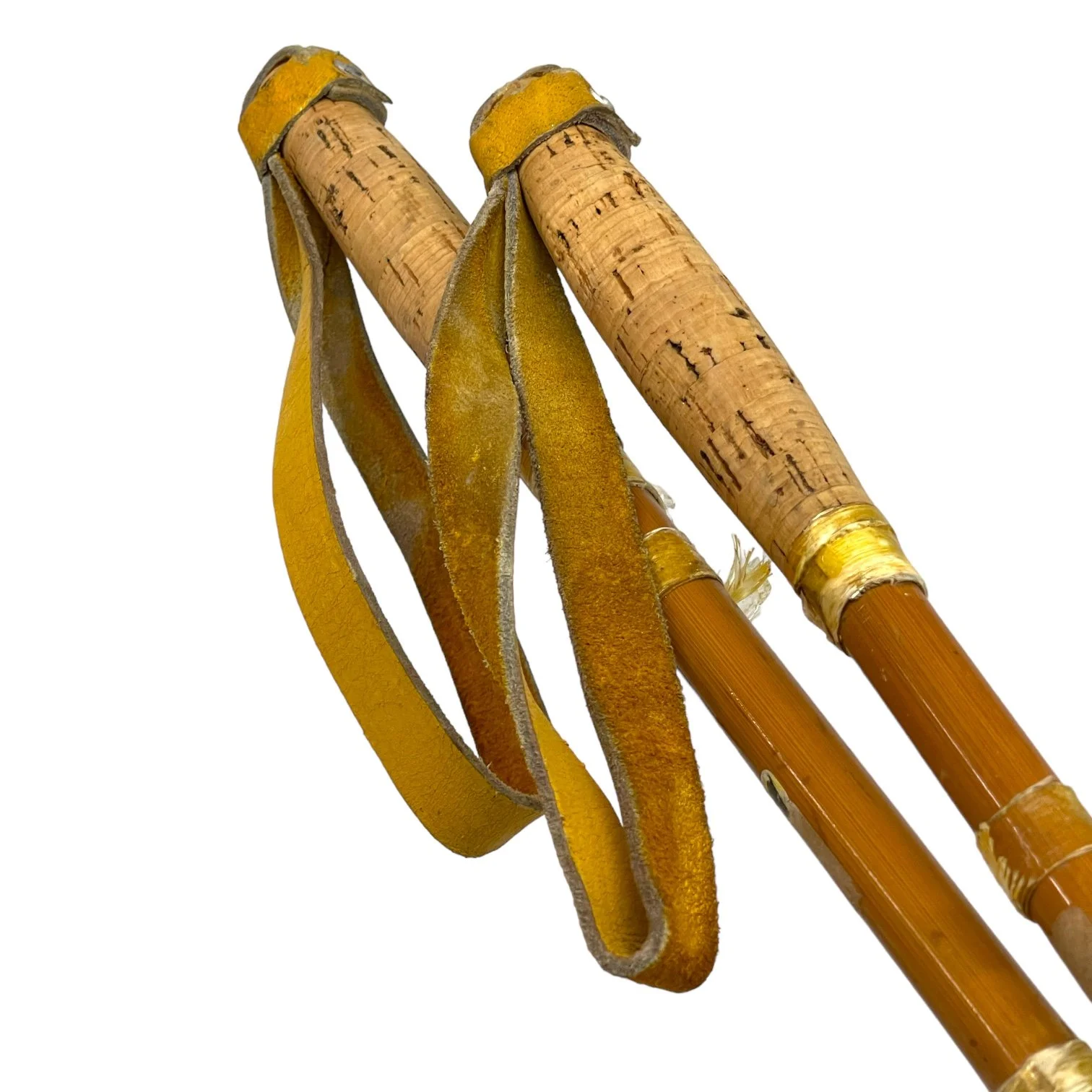 Pair of vintage wooden snowshoes with ski poles made of bamboo and cork - classic rustic winter gear perfect for cabin decor, lodge style, or outdoor adventures.