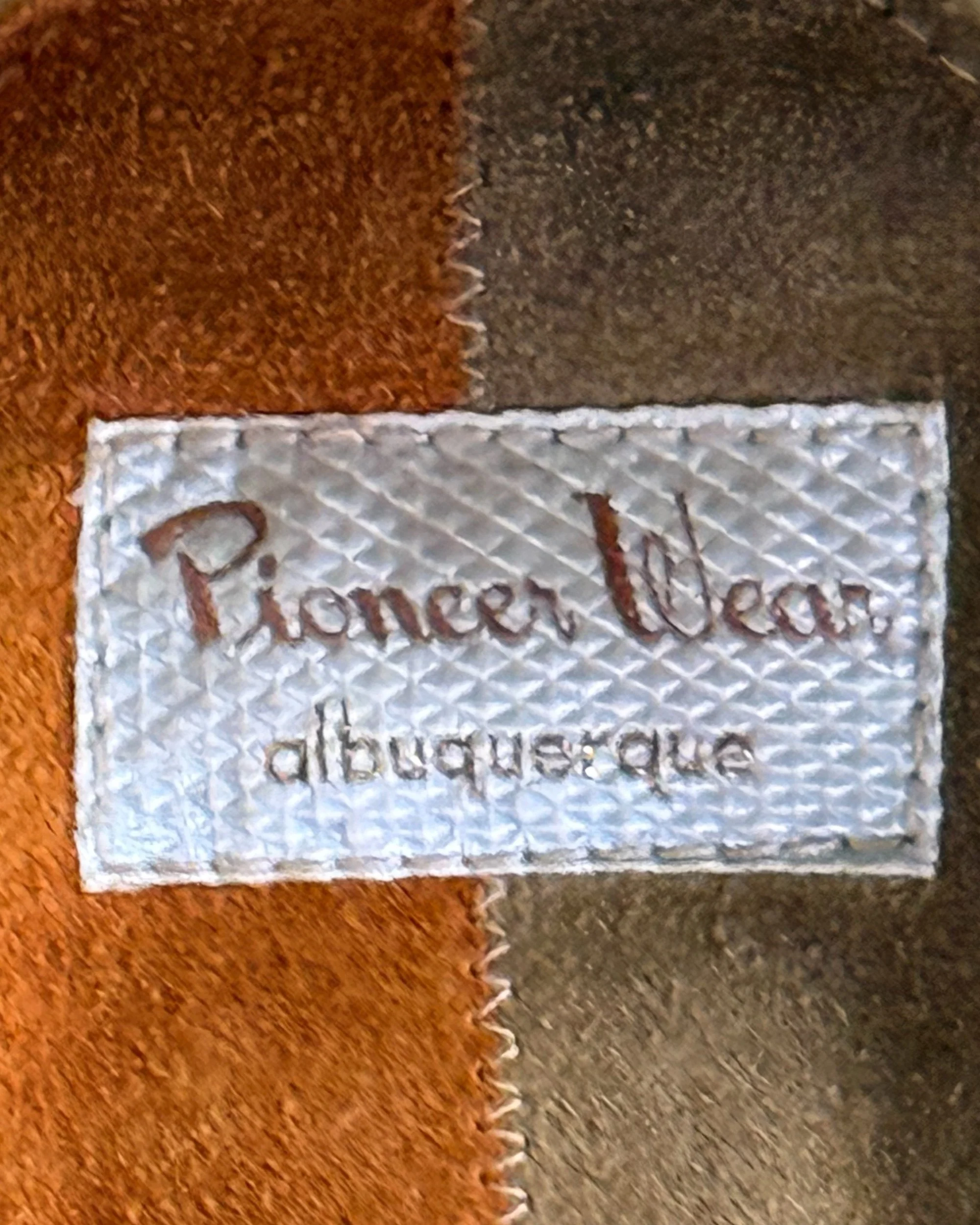 close up view of Pioneer Wear label on 1970s vintage suede leather jacket