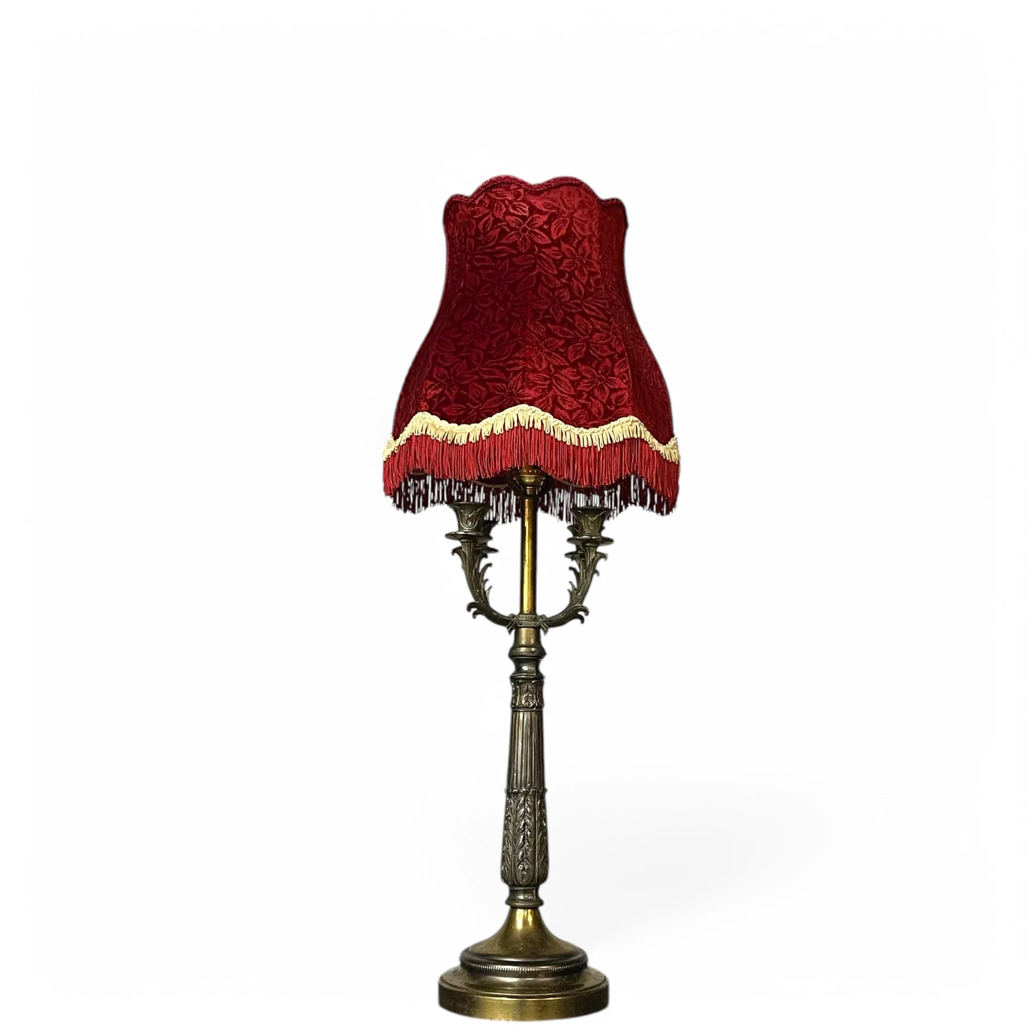 Vintage ornate table lamp in Victorian Gothic Revival style, with red fringe shade, & intricately designed 4-arm candlestick holder feature, perfect for gothic or vintage interiors.