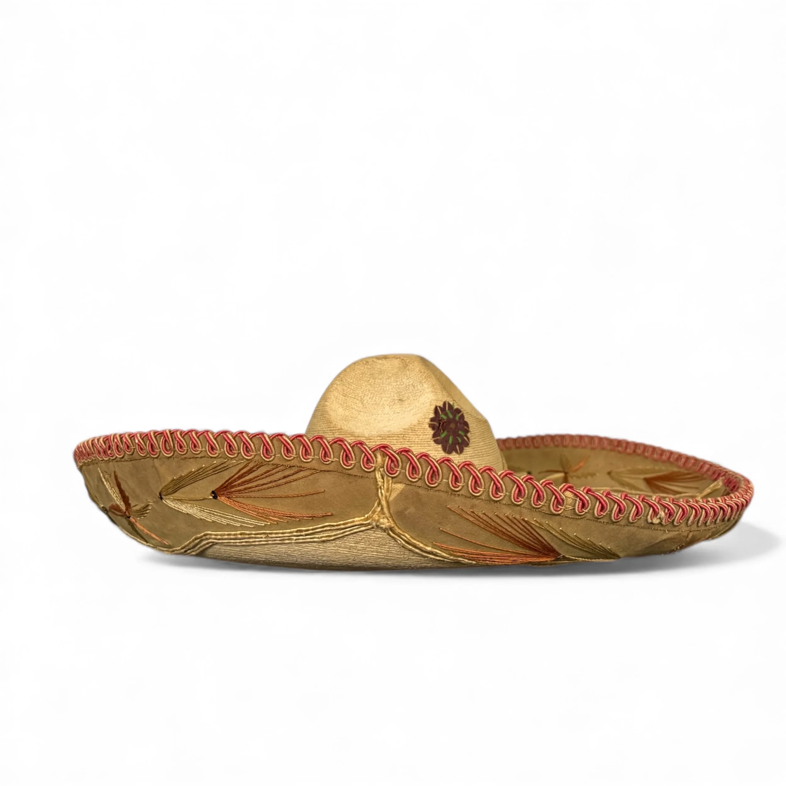 Side angle showing brim shape and palm weave and embroidered details on vintage sombrero