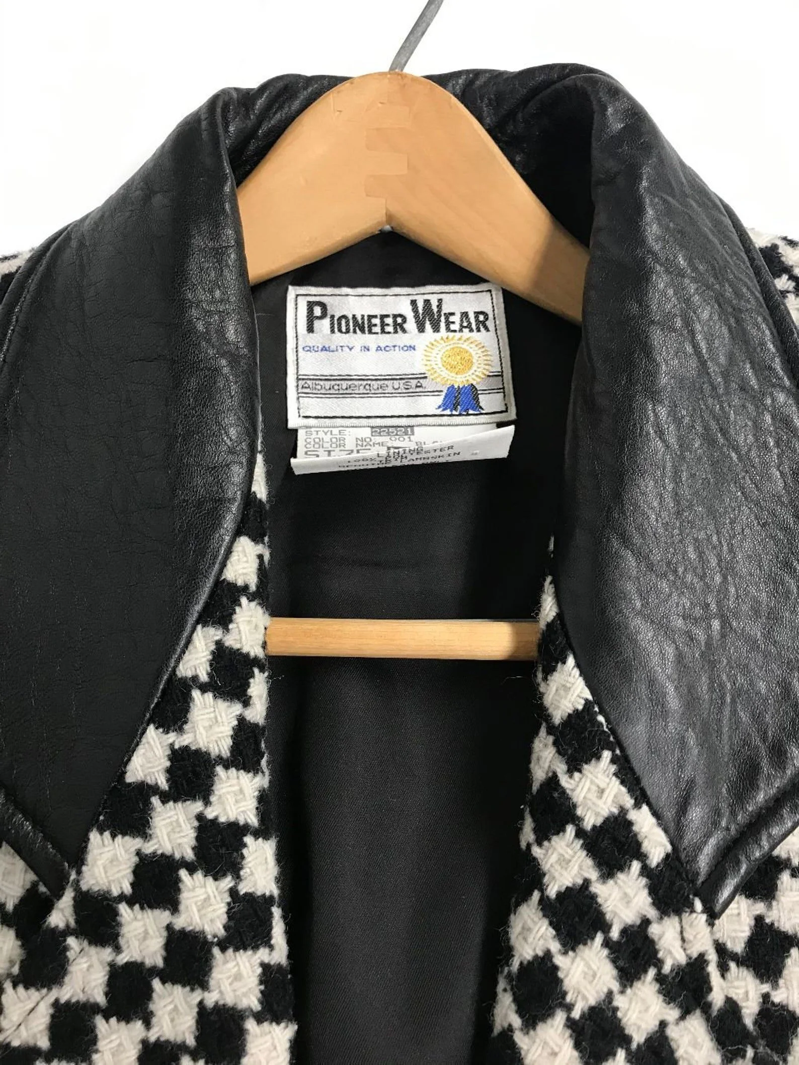 Vintage Pioneer Wear womens size medium black and white houndstooth coat, fully lined, trimmed in black leather, button front closure, two side pockets.