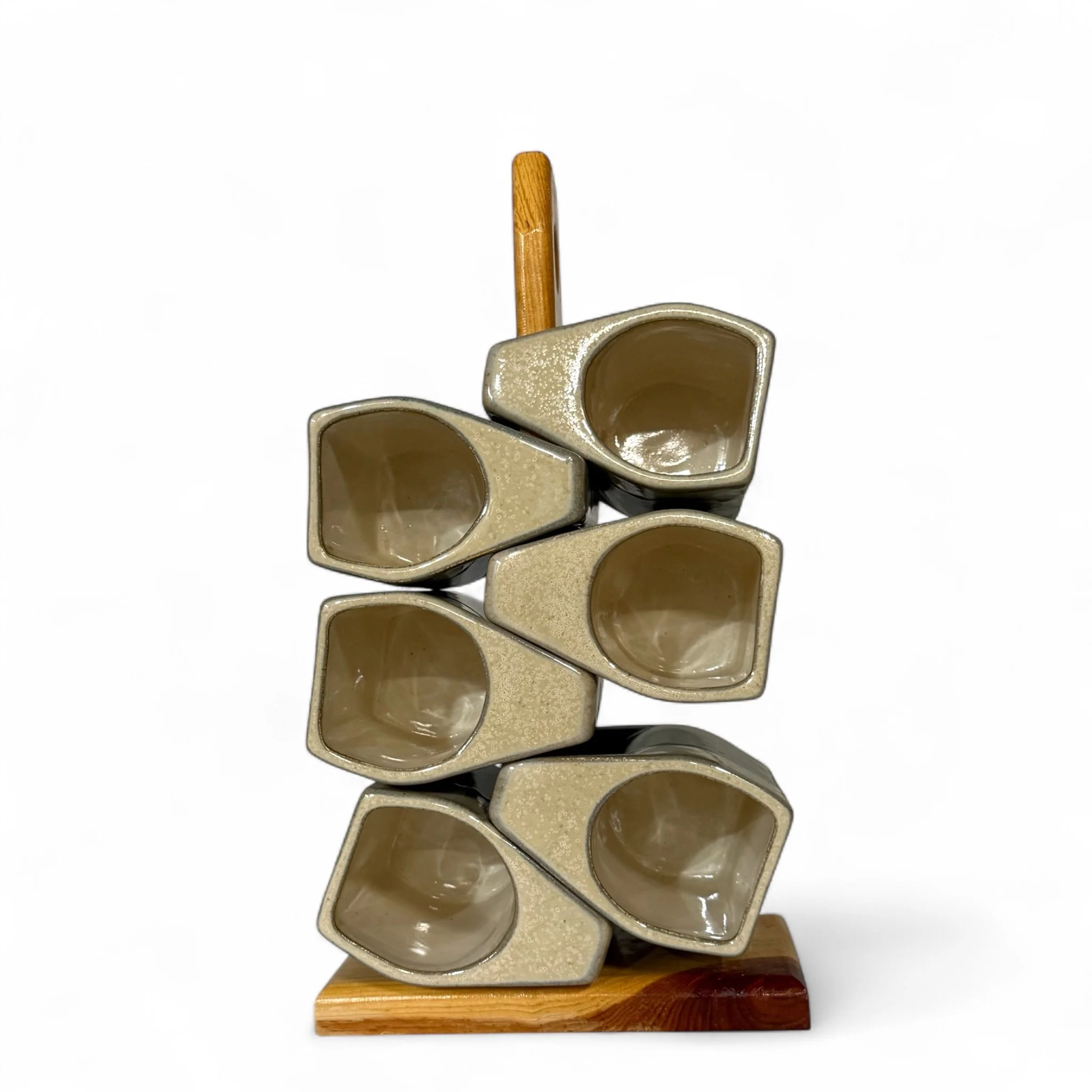 Set of six vintage Prado ceramic drip glaze mugs made in Mexico, displayed on a wooden stand, rustic stoneware with green and beige tones.