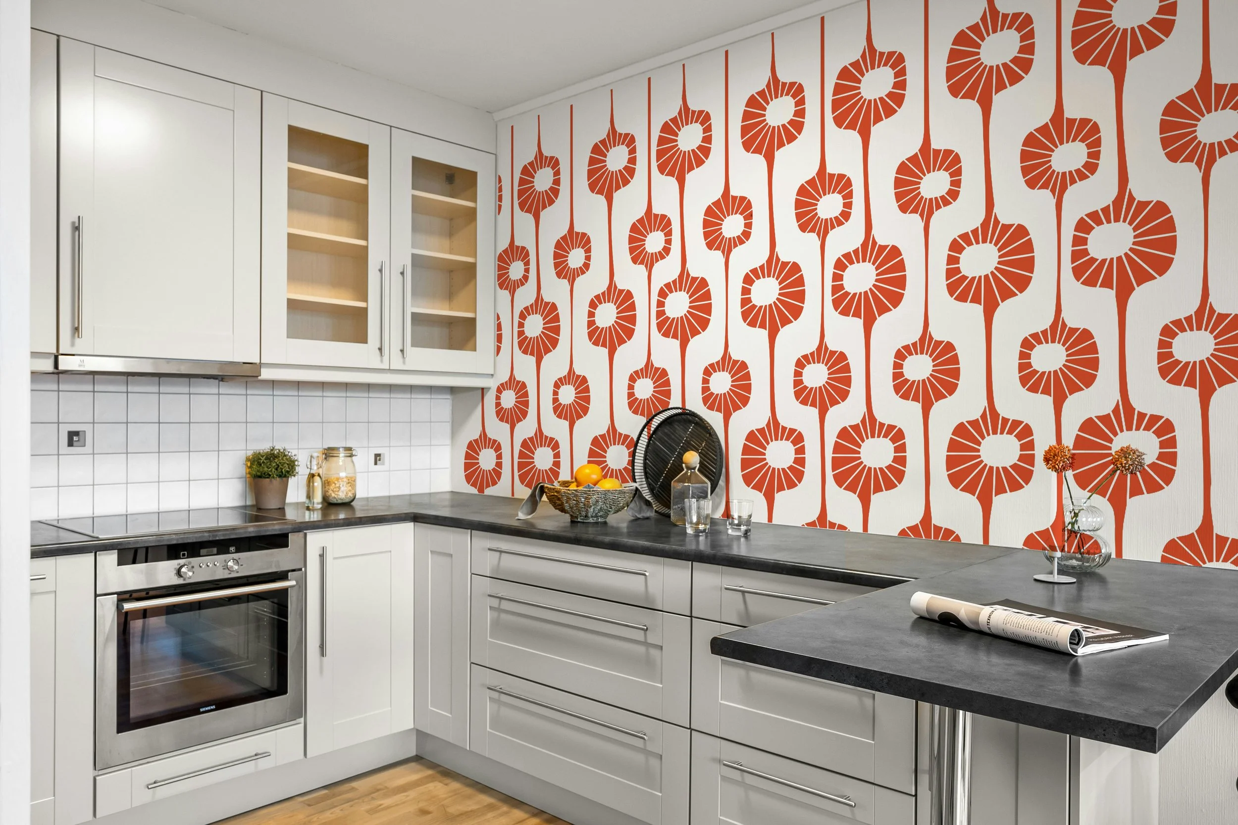 Modern kitchen with orange retro wall decor