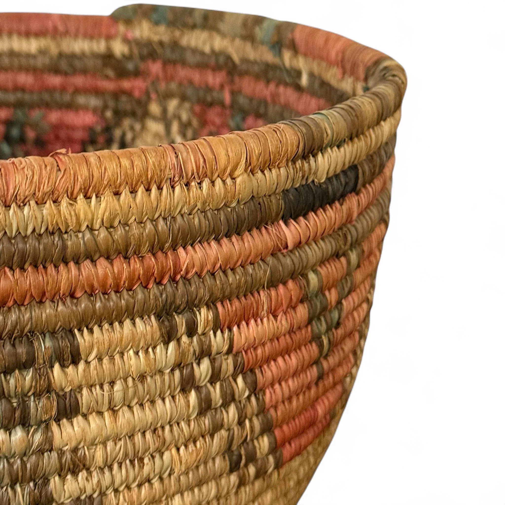Close up view of a large vintage Southwestern woven coil basket with bold geometric pattern. Perfect for rustic boho shelf styling or storage.