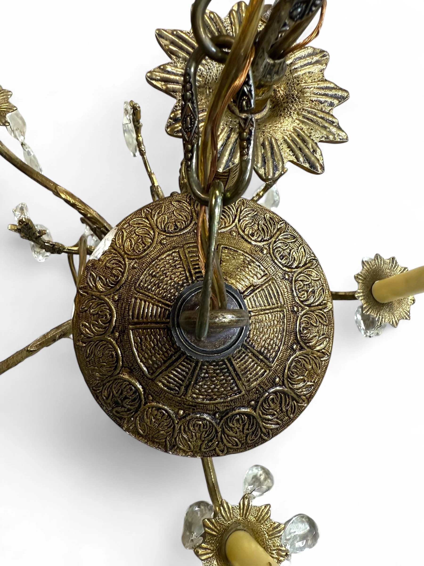 Vintage 1950s brass chandelier with five ornate candelabra arms, plastic drip candle covers, made in Spain, Victorian and Hollywood Regency style.