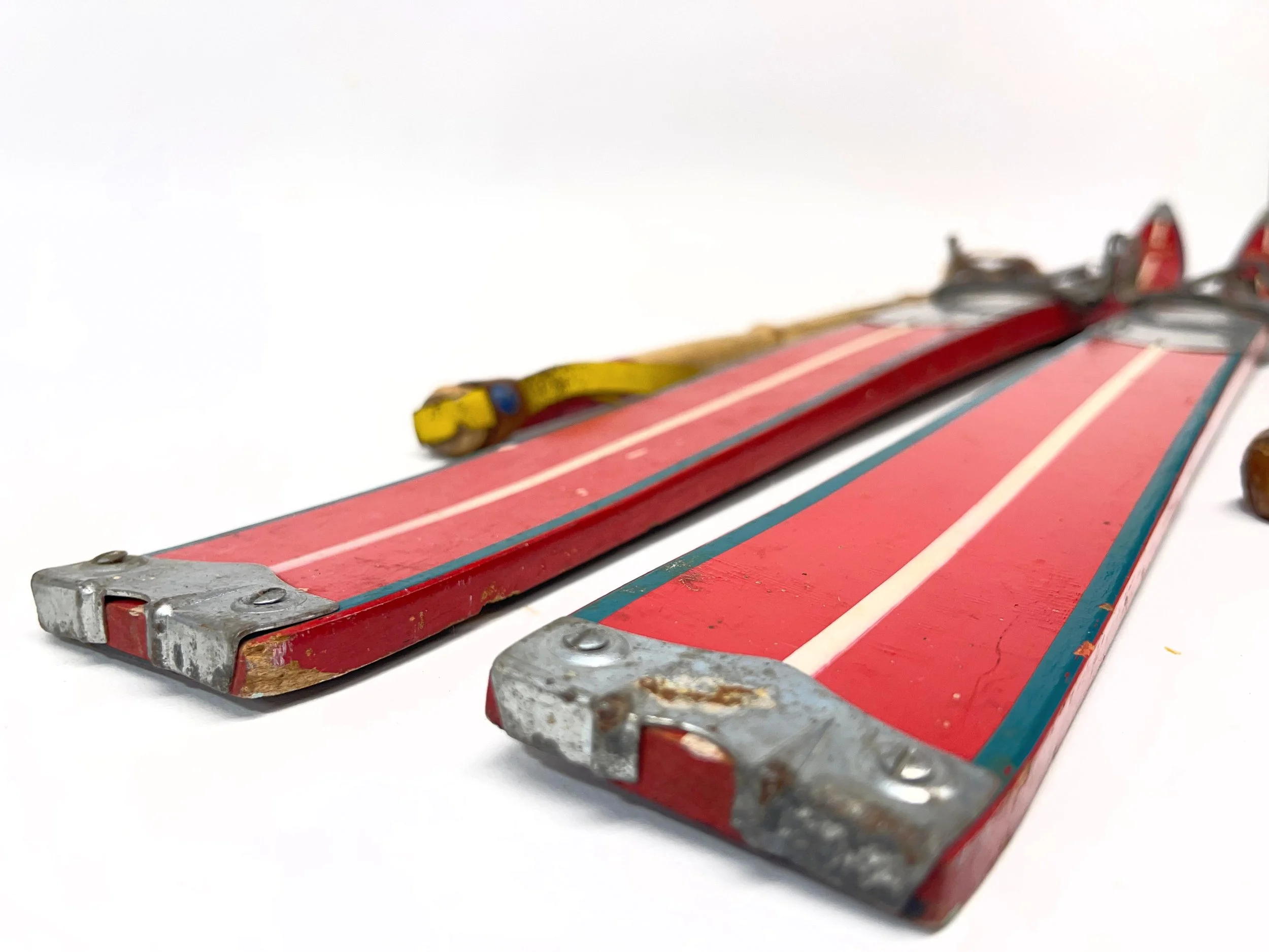 Vintage pair of Sportcraft Champion red and silver wooden snow skis for kids complete with vintage bamboo ski poles.