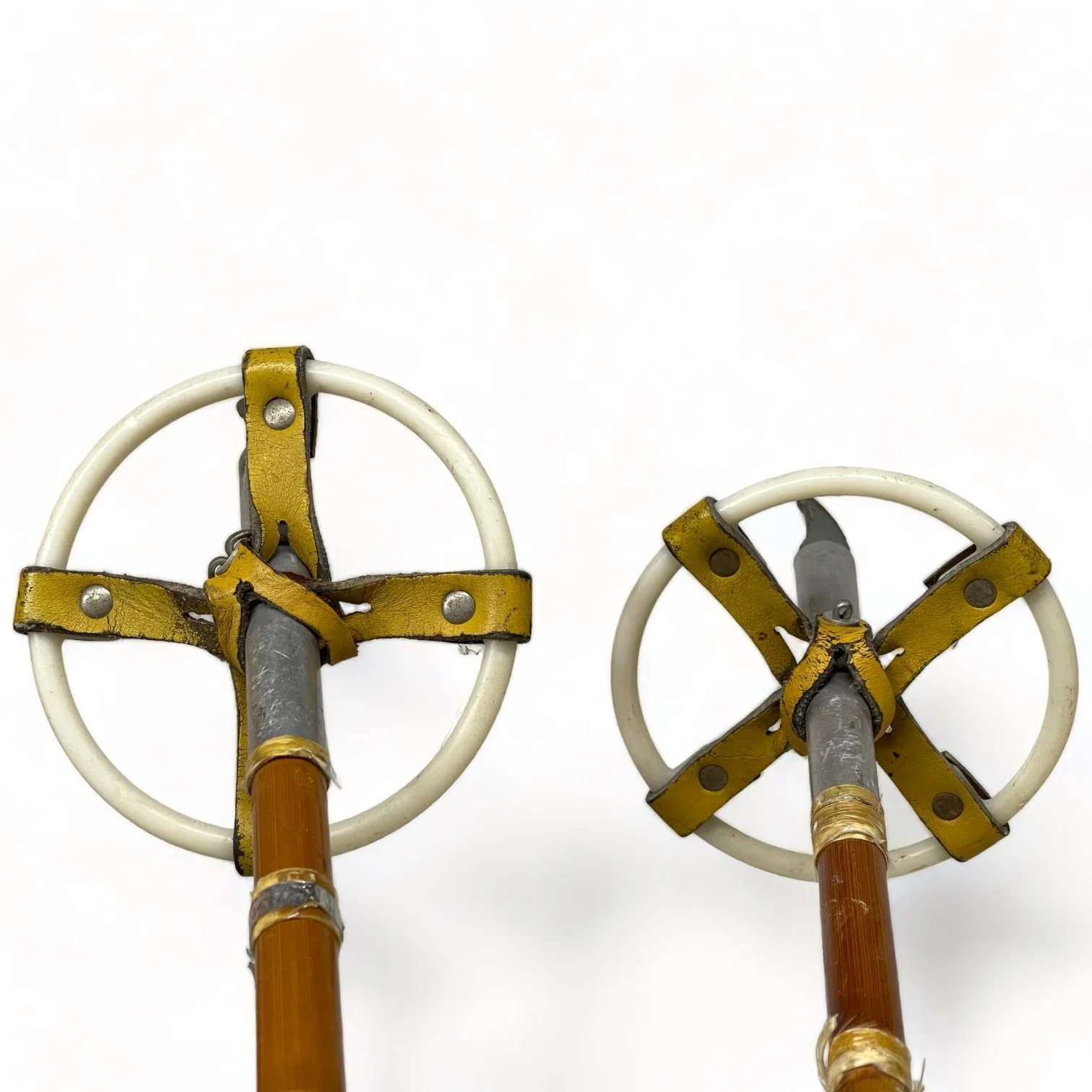 Pair of vintage wooden snowshoes with ski poles made of bamboo and cork - classic rustic winter gear perfect for cabin decor, lodge style, or outdoor adventures.