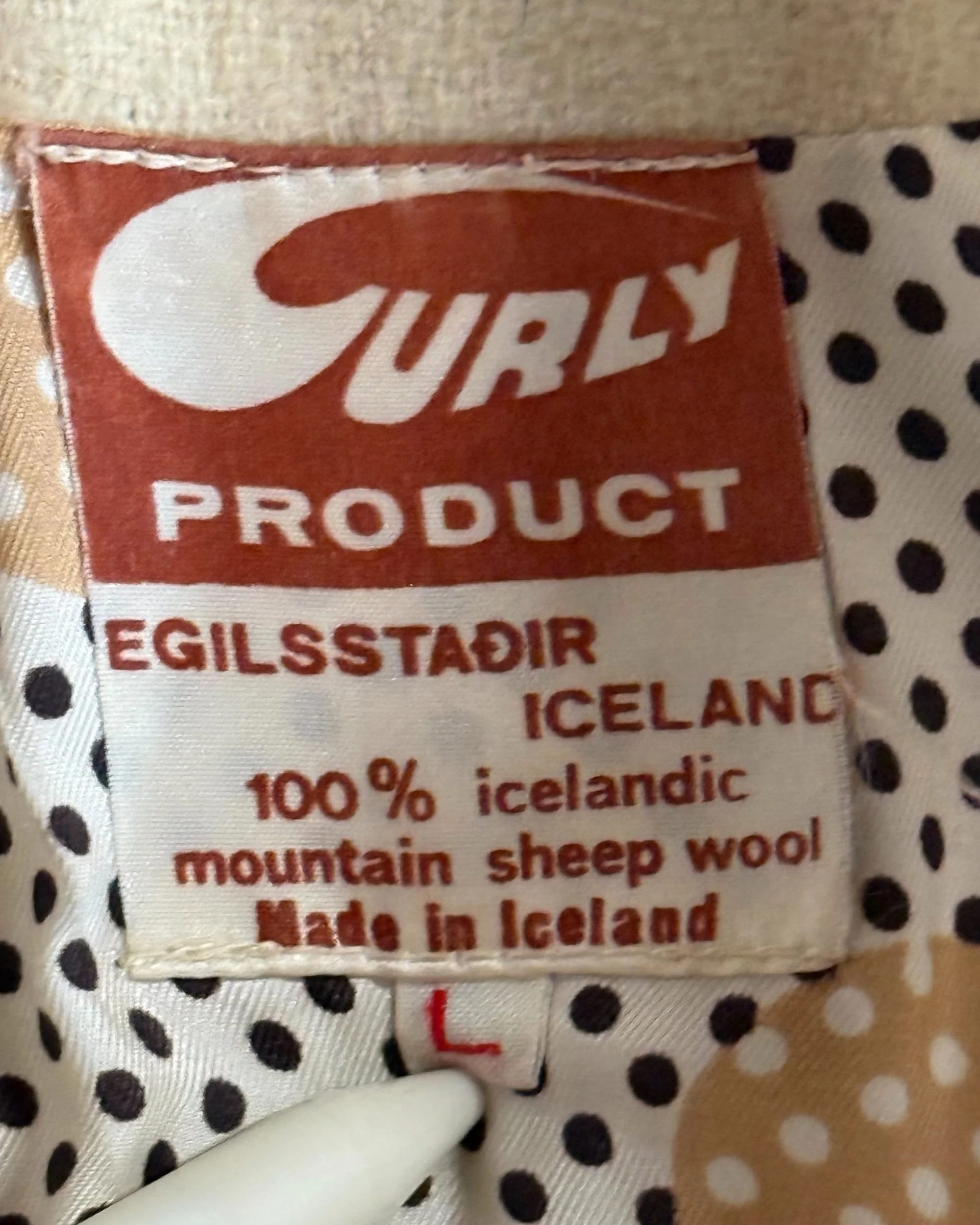 close up of vintage 1970s label that reads Curly Product, Egilsstadir Iceland, 100% icelandic mountain sheep wool, made in Iceland.
