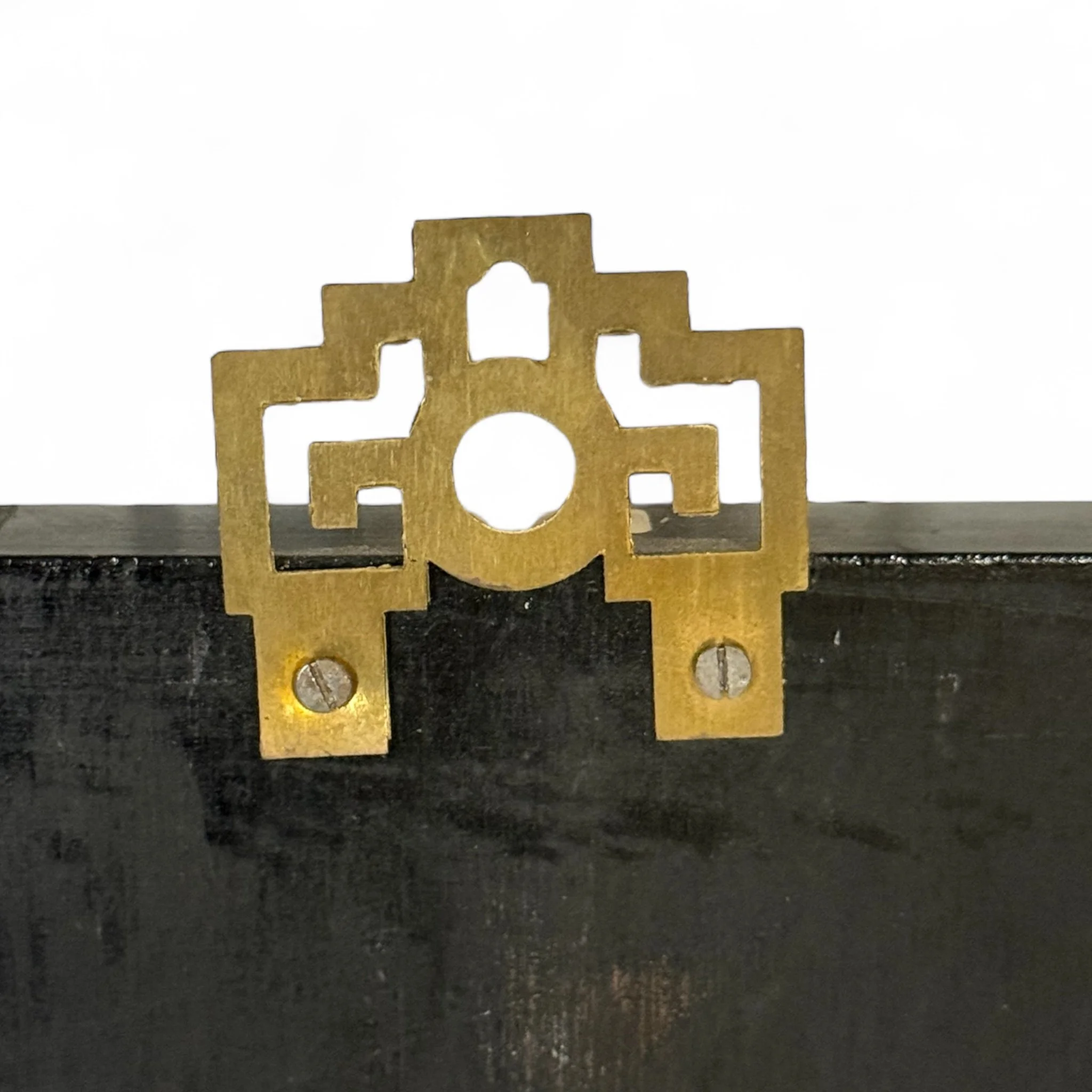 Close-up hanging hardware on a lacquer wood panel