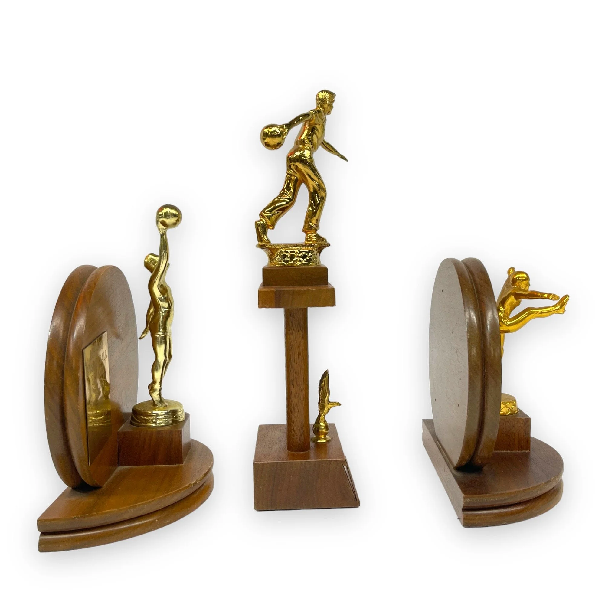 Vintage set of 3 trophies in mid century modern designs. Trophies are from the 50s and 60s and are made of wood with gold metal engraved plates.