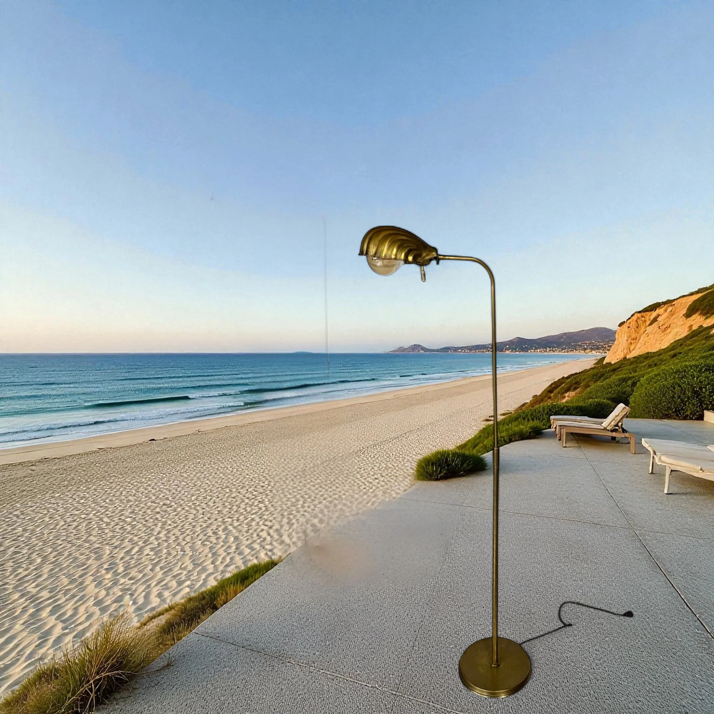 Vintage brass clam shell floor lamp full view standing on a patio on the beach with a view of the ocean