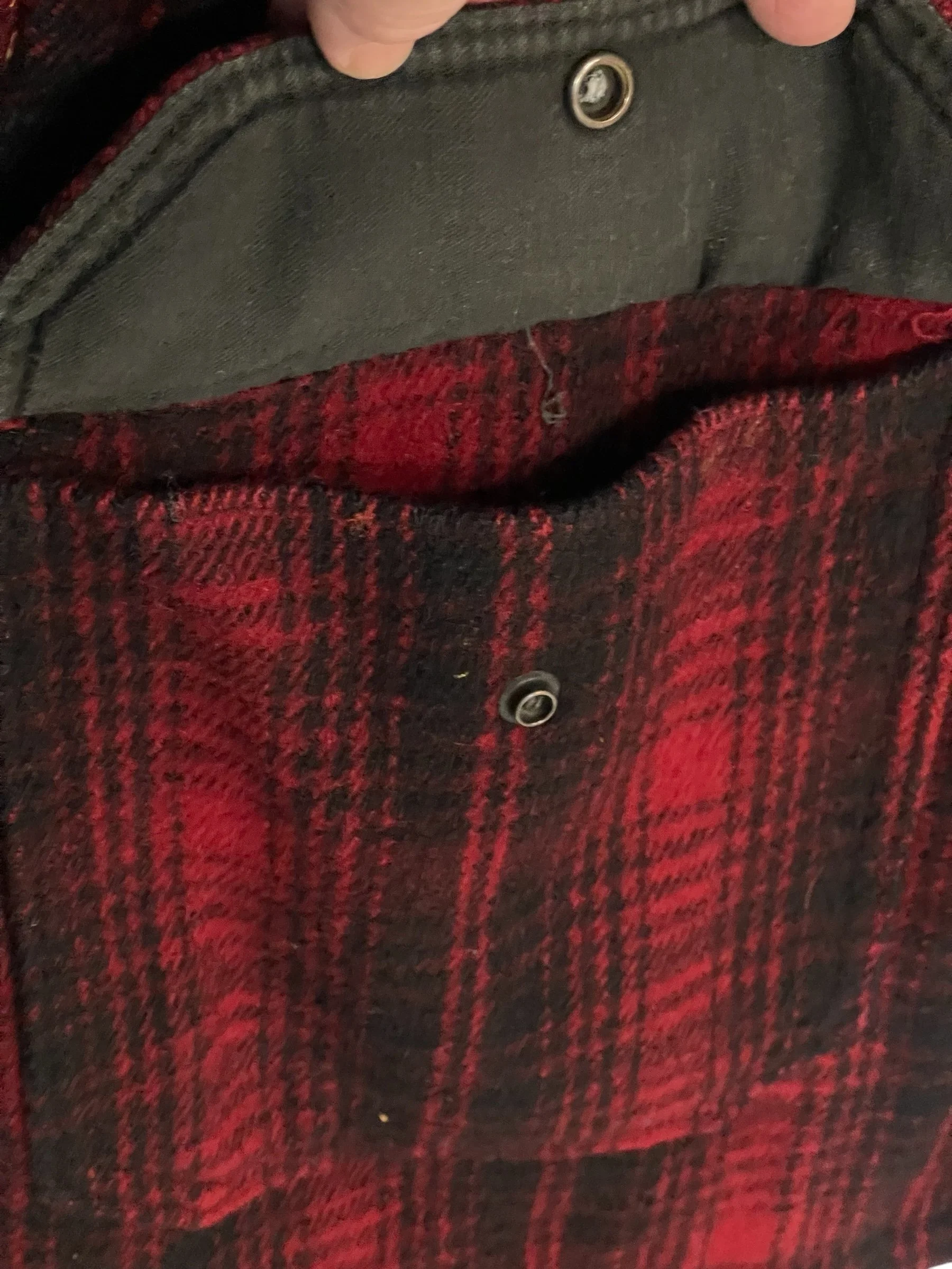 Vintage 70s Woolrich black red plaid jacket. Size 46 long, fully lined, hidden button front closure with 6 front pockets with snap closure,  full game pocket. This Mackinaw style coat Made in USA.