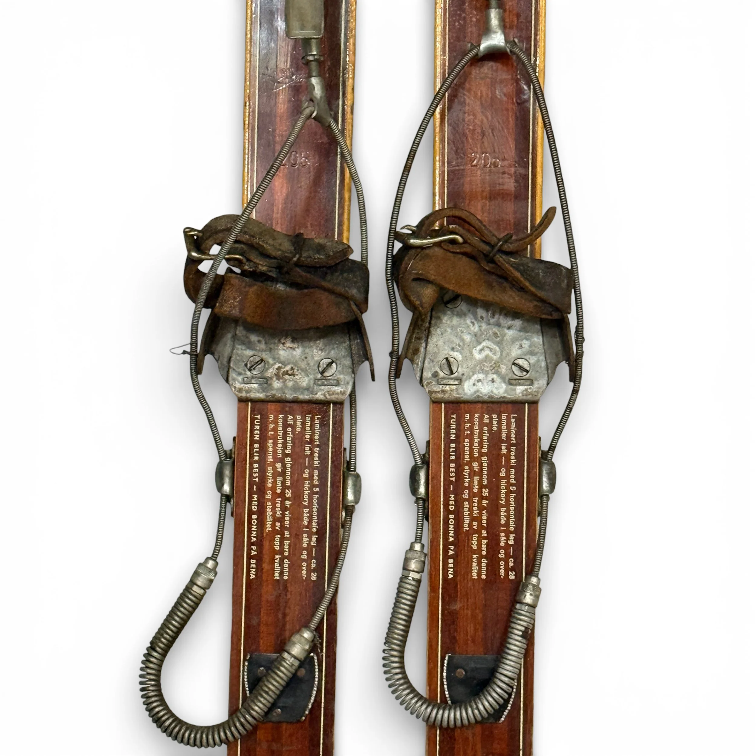 close up view of metal bindings on vintage wooden snow skis