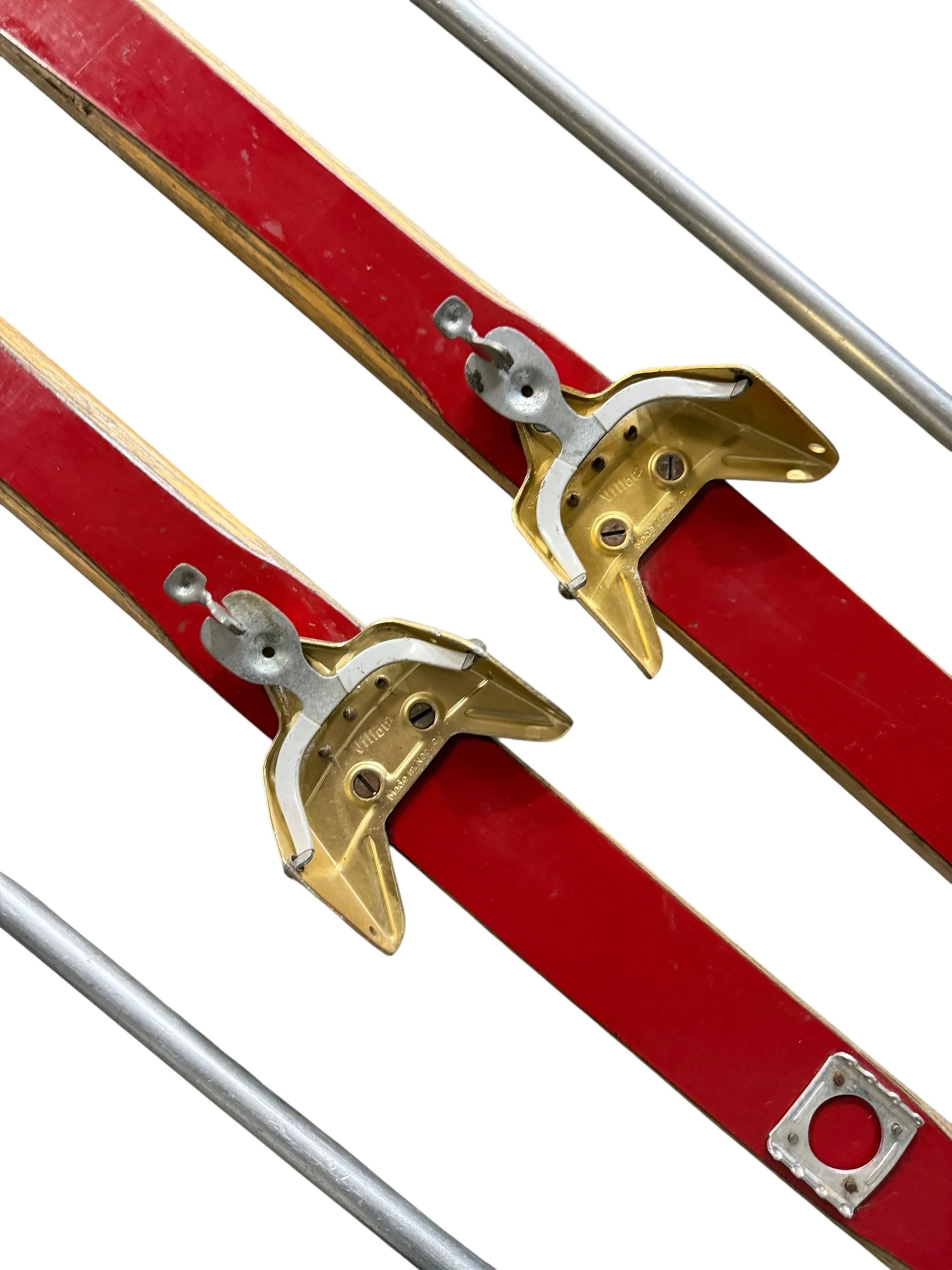 close up view of vintage Villom metal bindings on vintage red snow skis