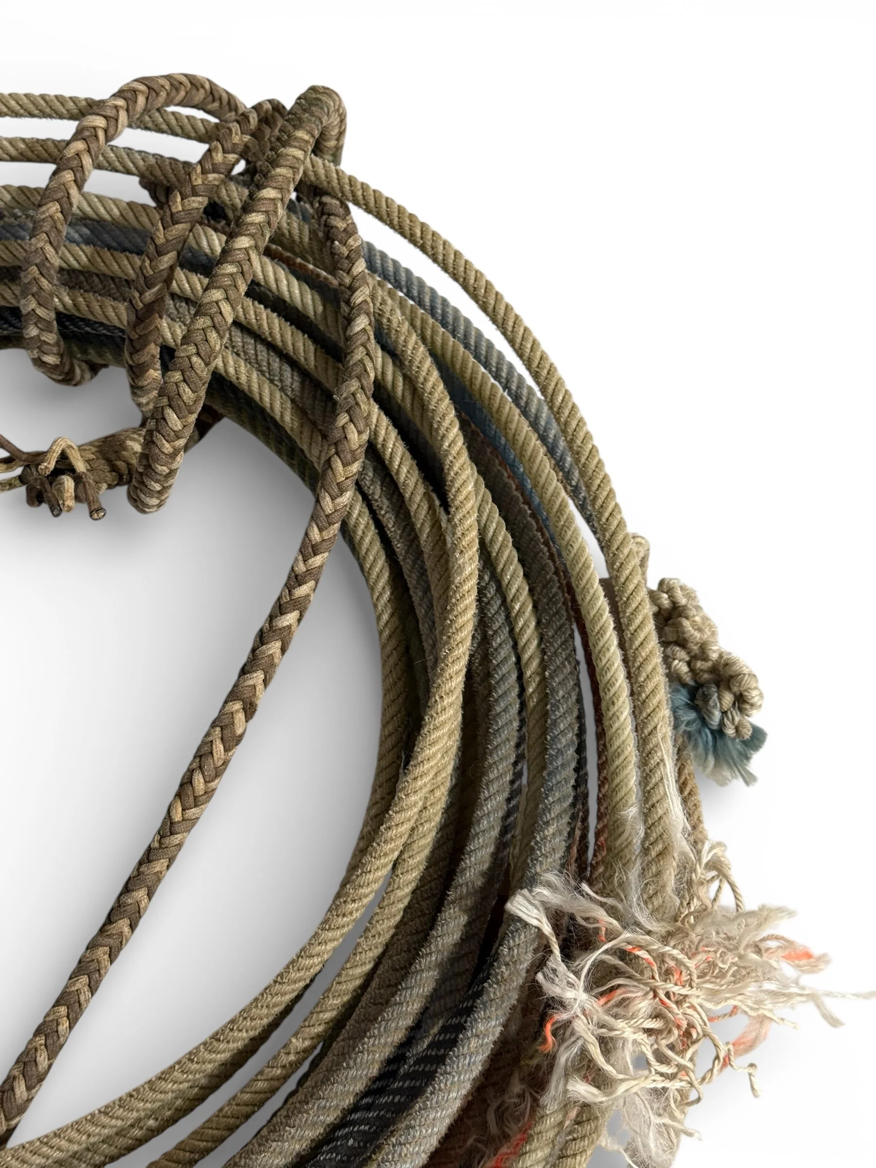 close up of various vintage lasso ropes showing detailed patterns and natural fraying from use