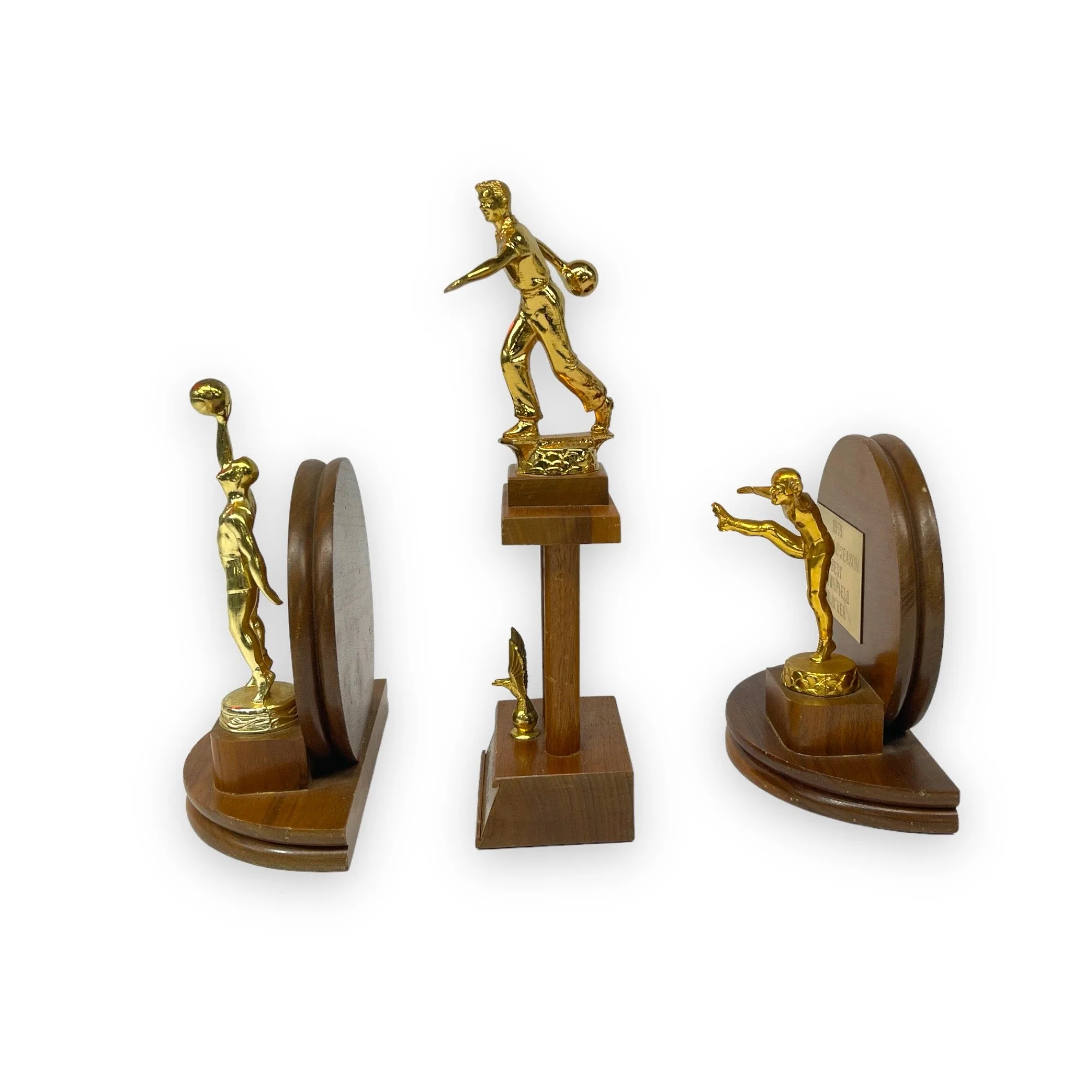 Vintage set of 3 trophies in mid century modern designs. Trophies are from the 50s and 60s and are made of wood with gold metal engraved plates.