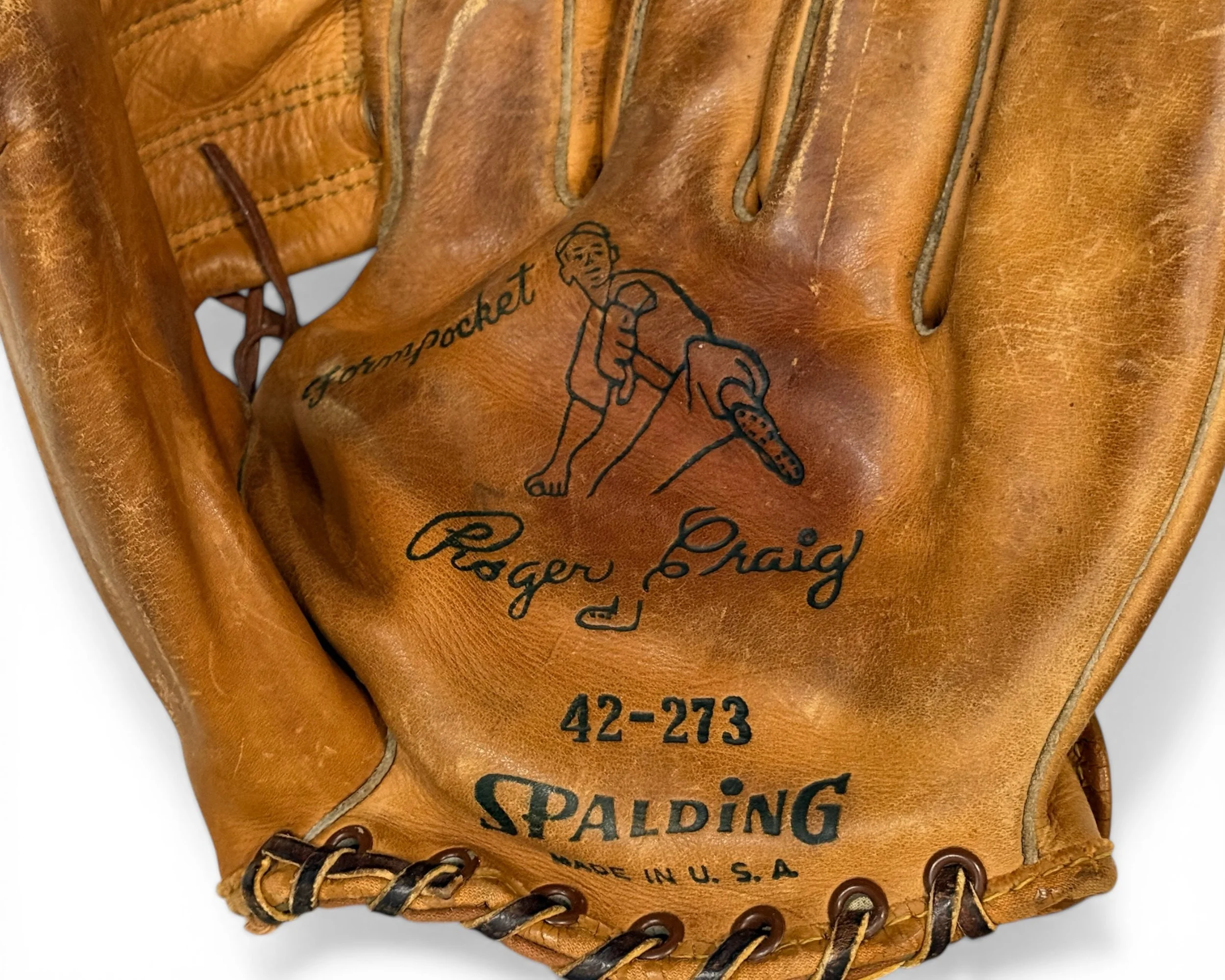 Close up logo and text on a vintage leather baseball glove that reads "Form Pocket, Roger Craig, 42-243 Spalding, made in USA