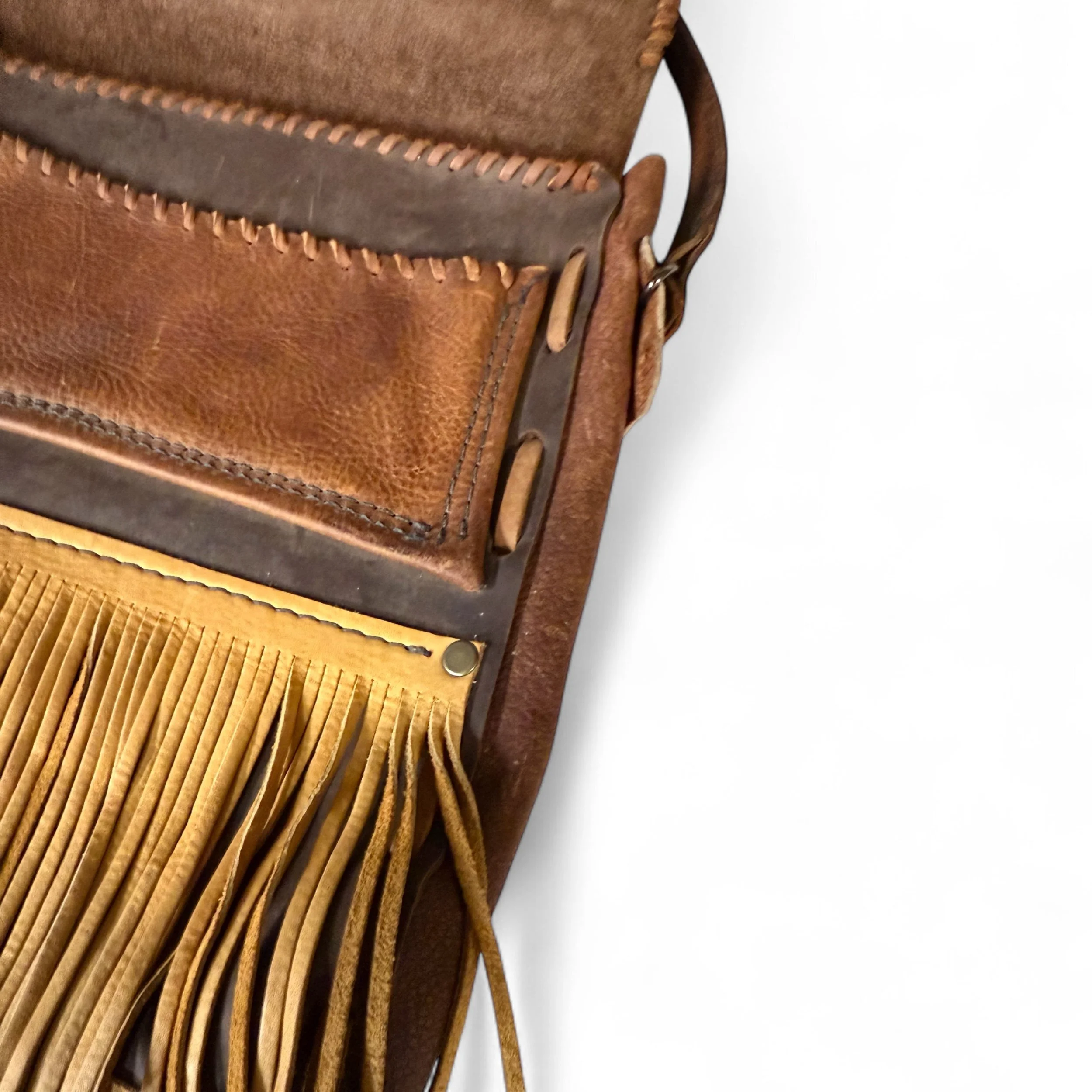 Close up view of interior whip stitch leather pocket and fringe detailing.