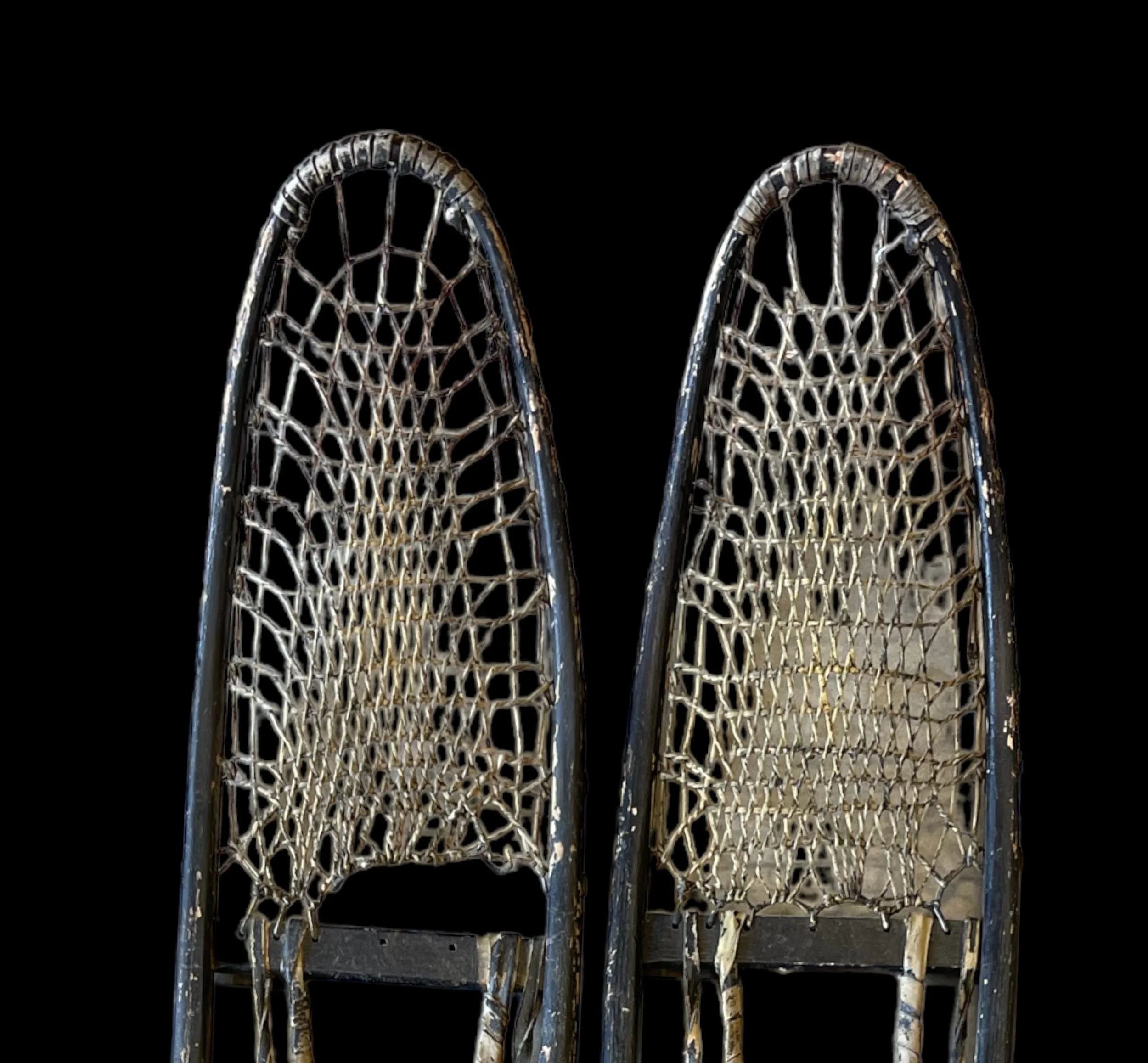 Vintage pair C.A. Lund Wooden Snowshoes with leather bindings.