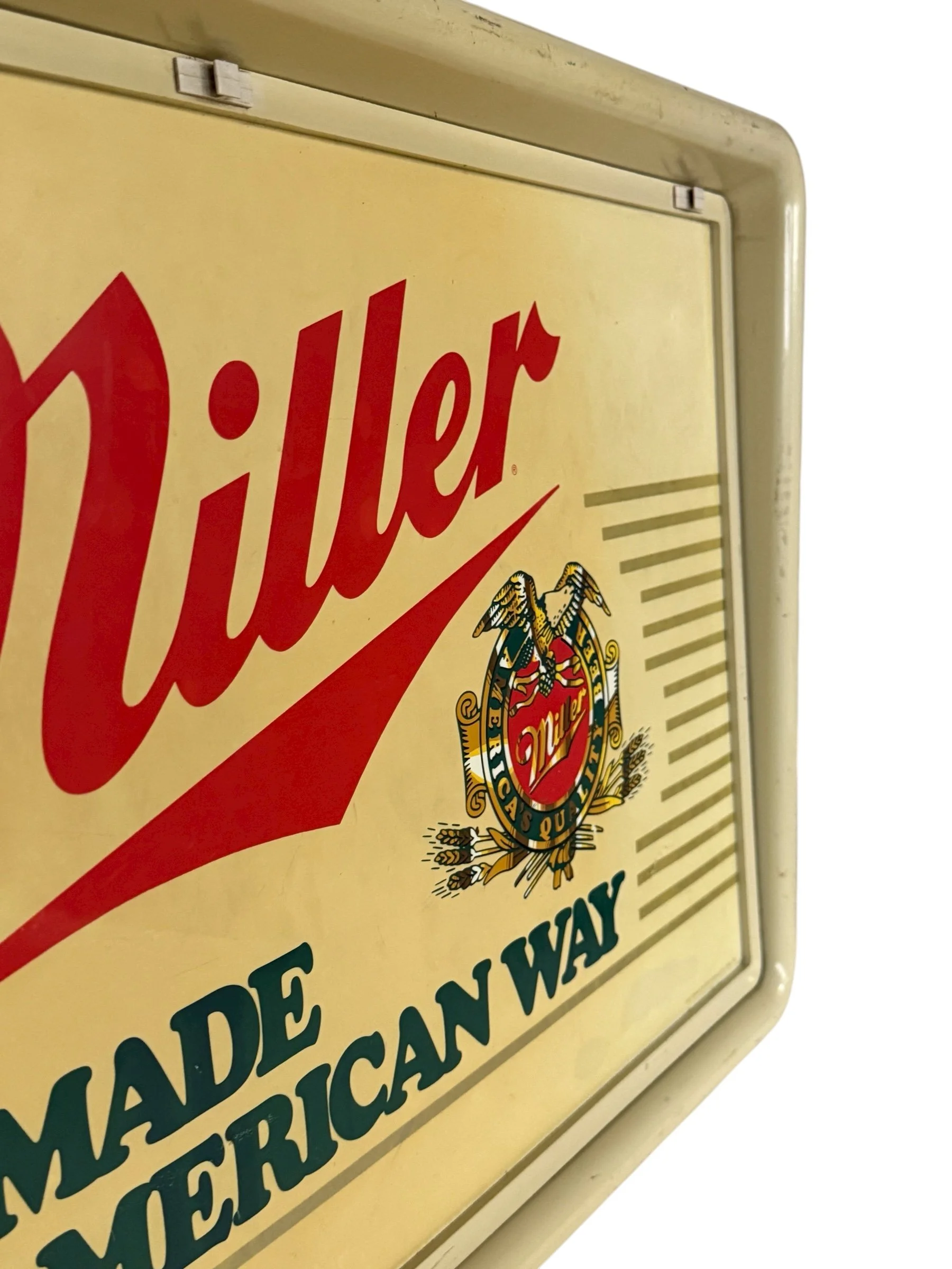 Side view Miller sign with lights off showing surface texture.