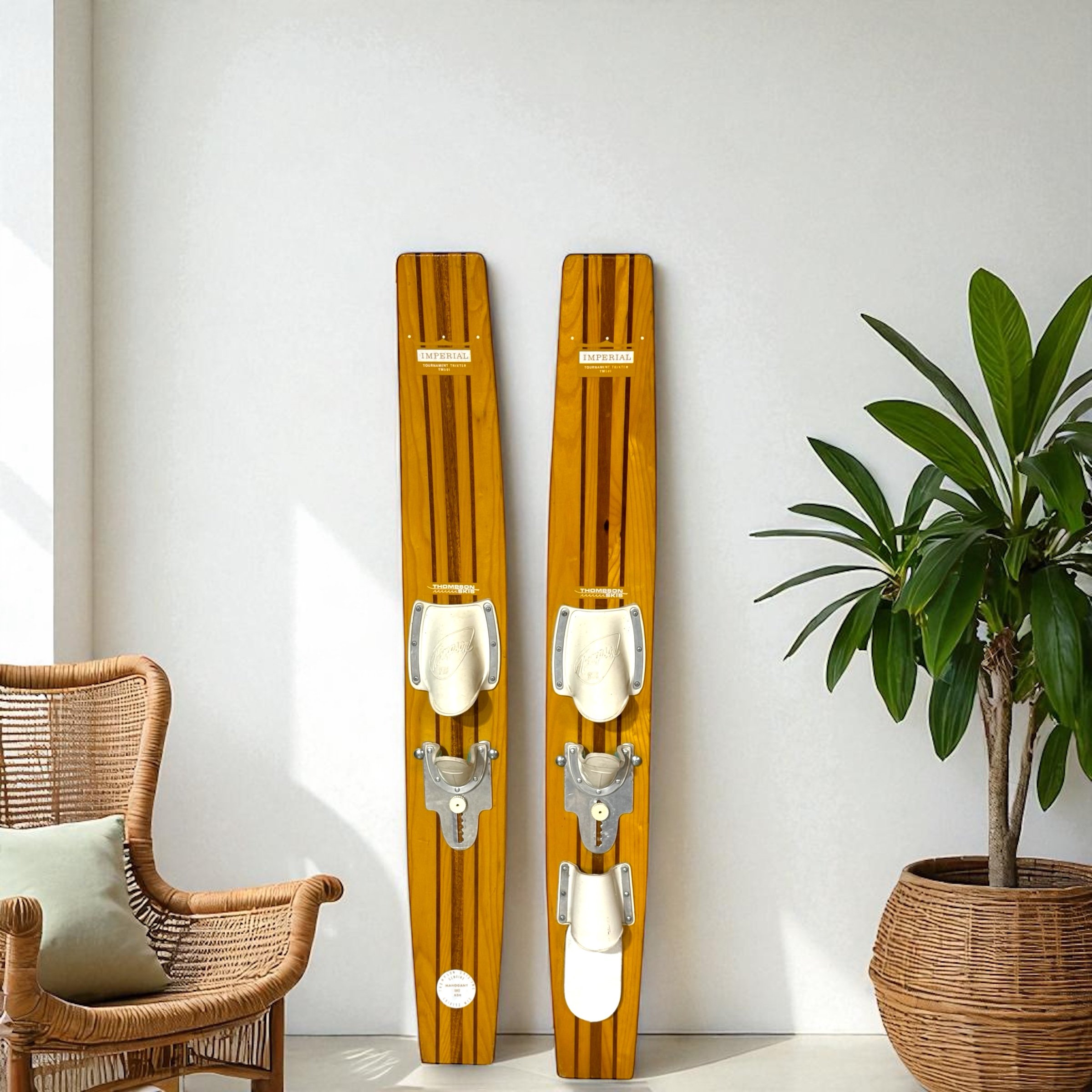 Pair of vintage Imperial wooden water skis made of mahogany and ash styled in the interior of a modern beach home.