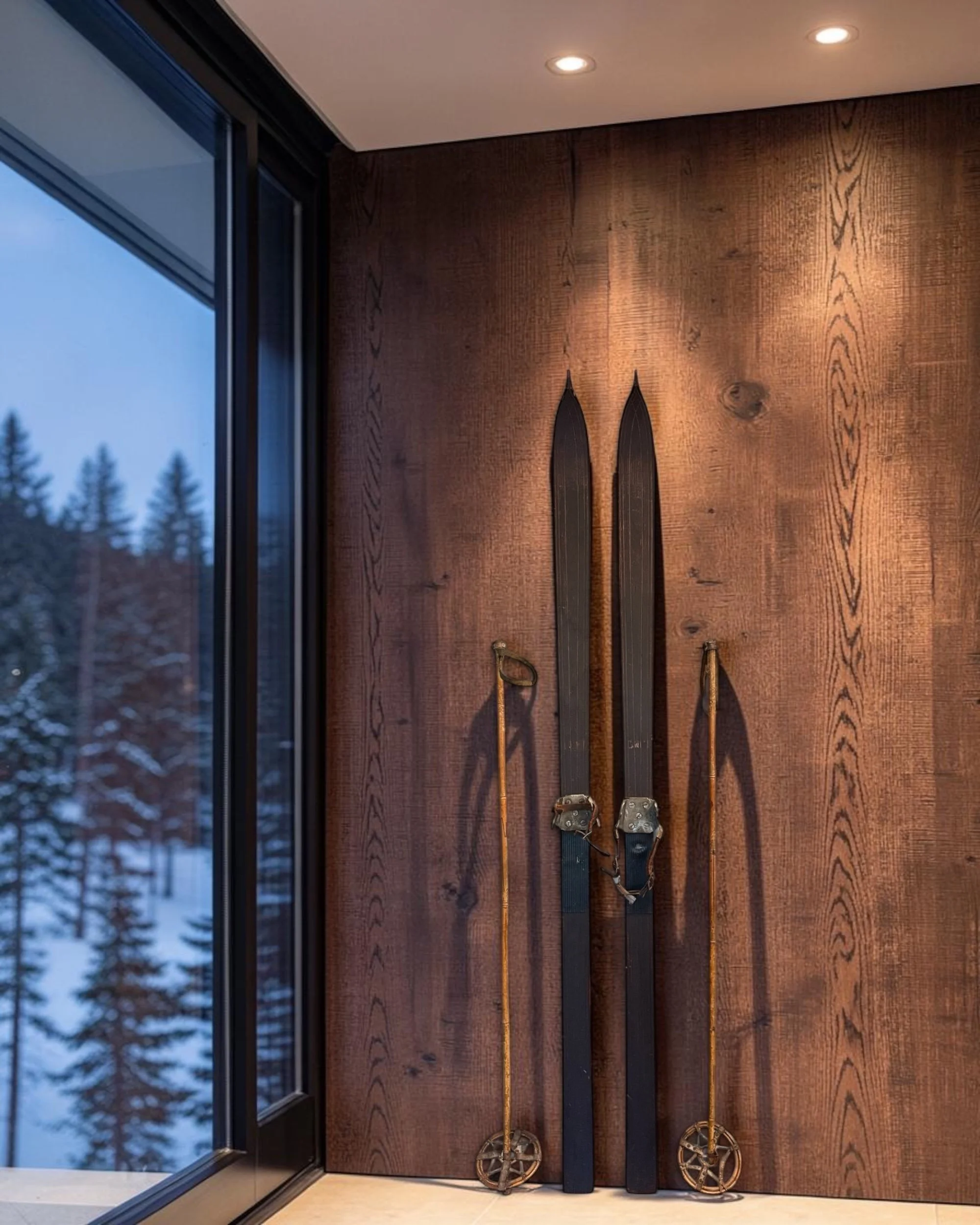 antique wooden snow skis and poles styled in a modern lodge home