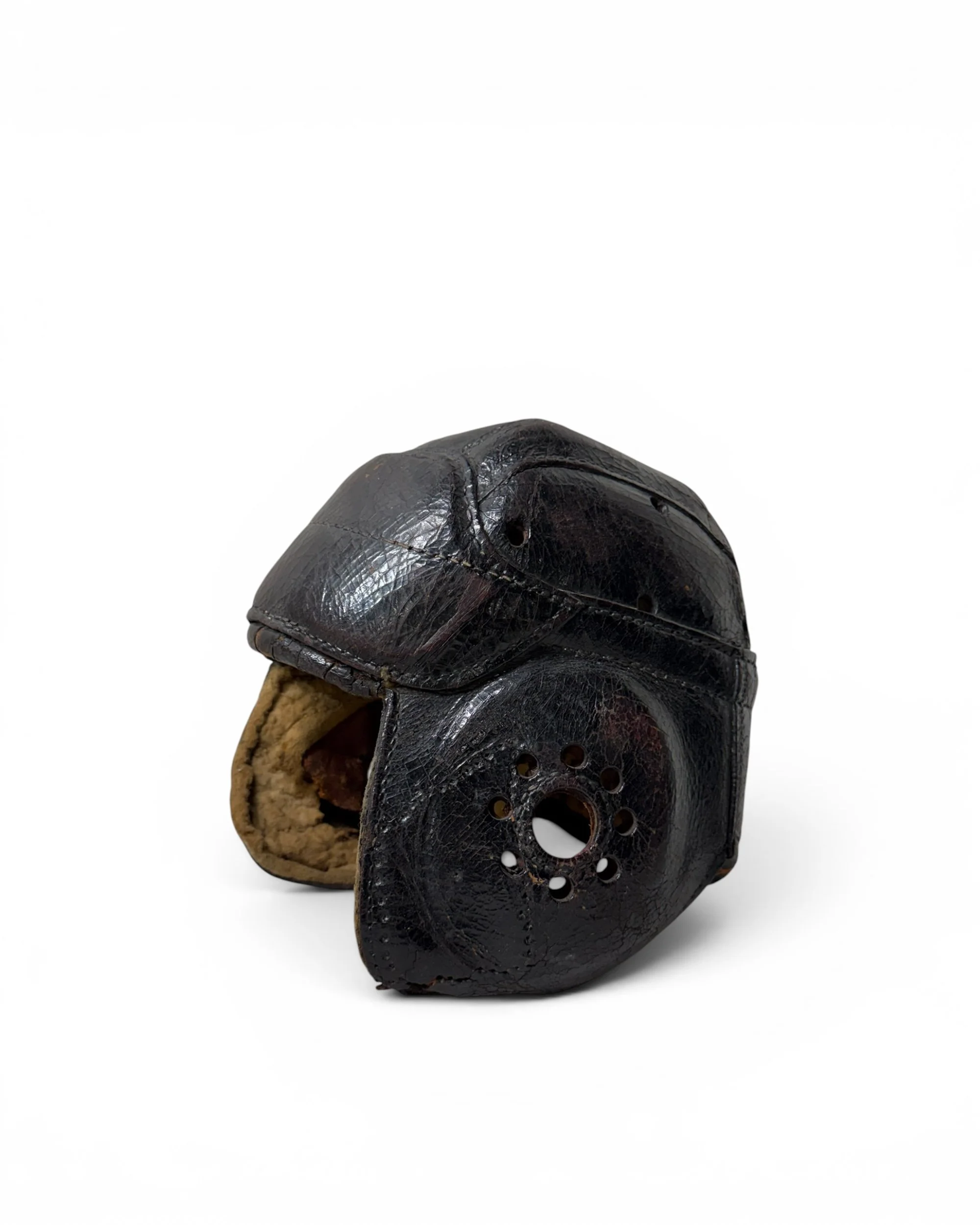 Vintage leather football helmet with dark aged leather exterior.