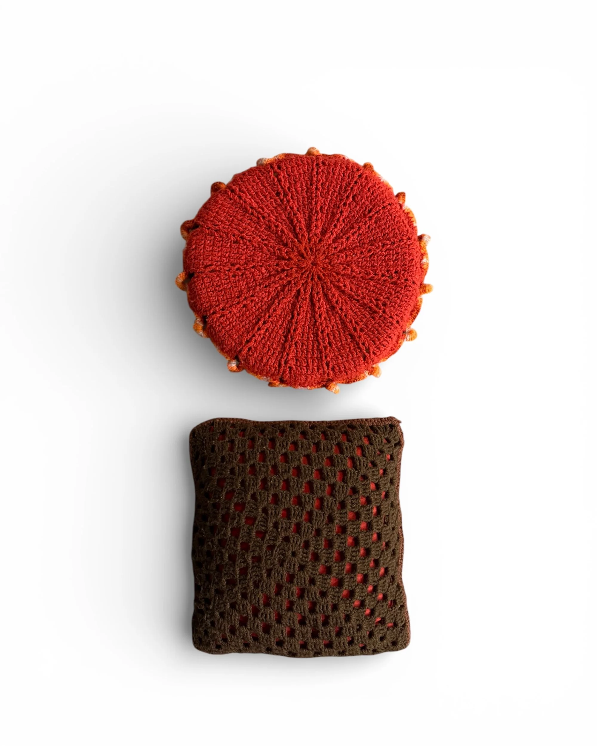 backside of vintage handmade red circle and brown square crochet accent throw pillows