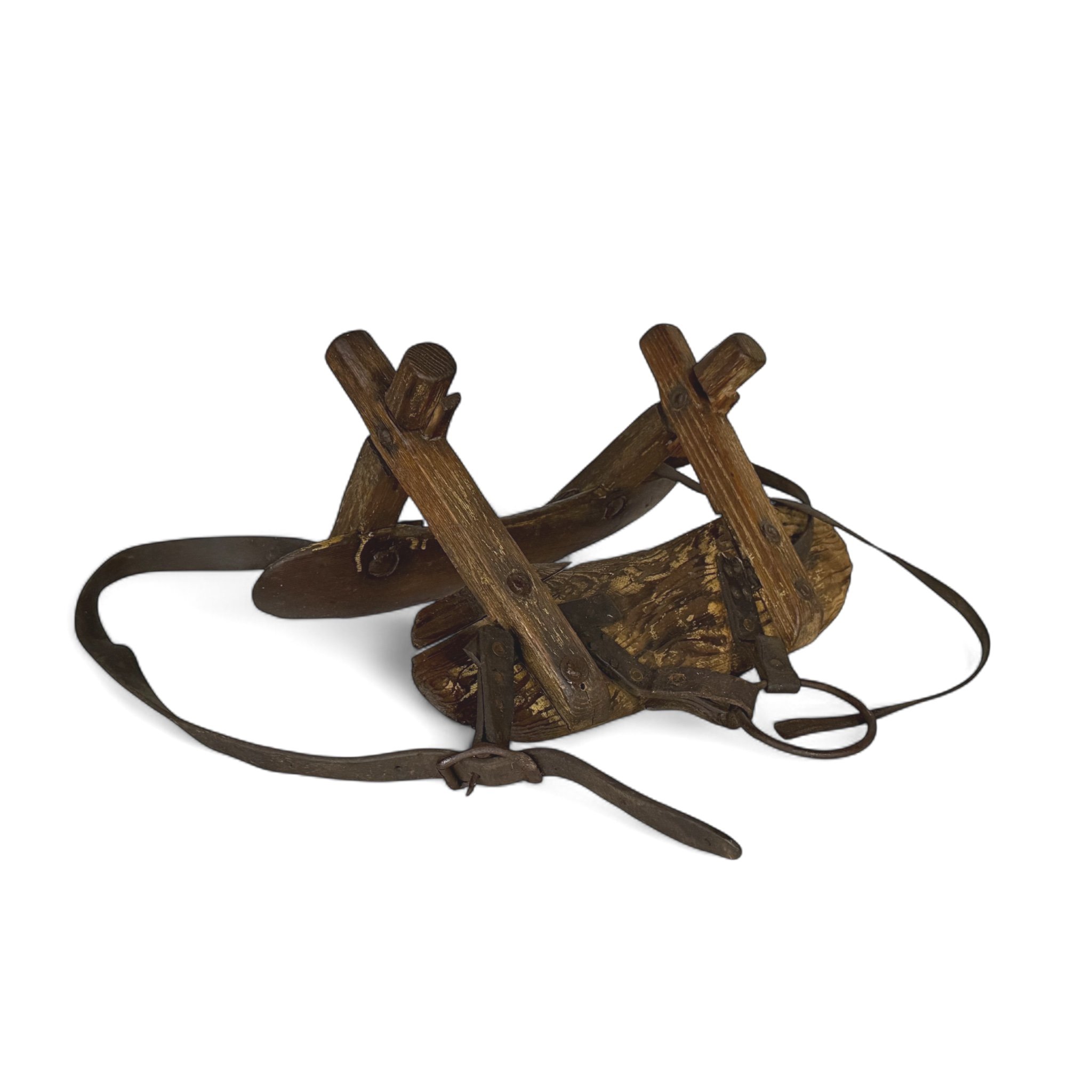 Antique wooden pack saddle with rustic leather straps and metal hardware - vintage equestrian gear for Western decor or collector display.